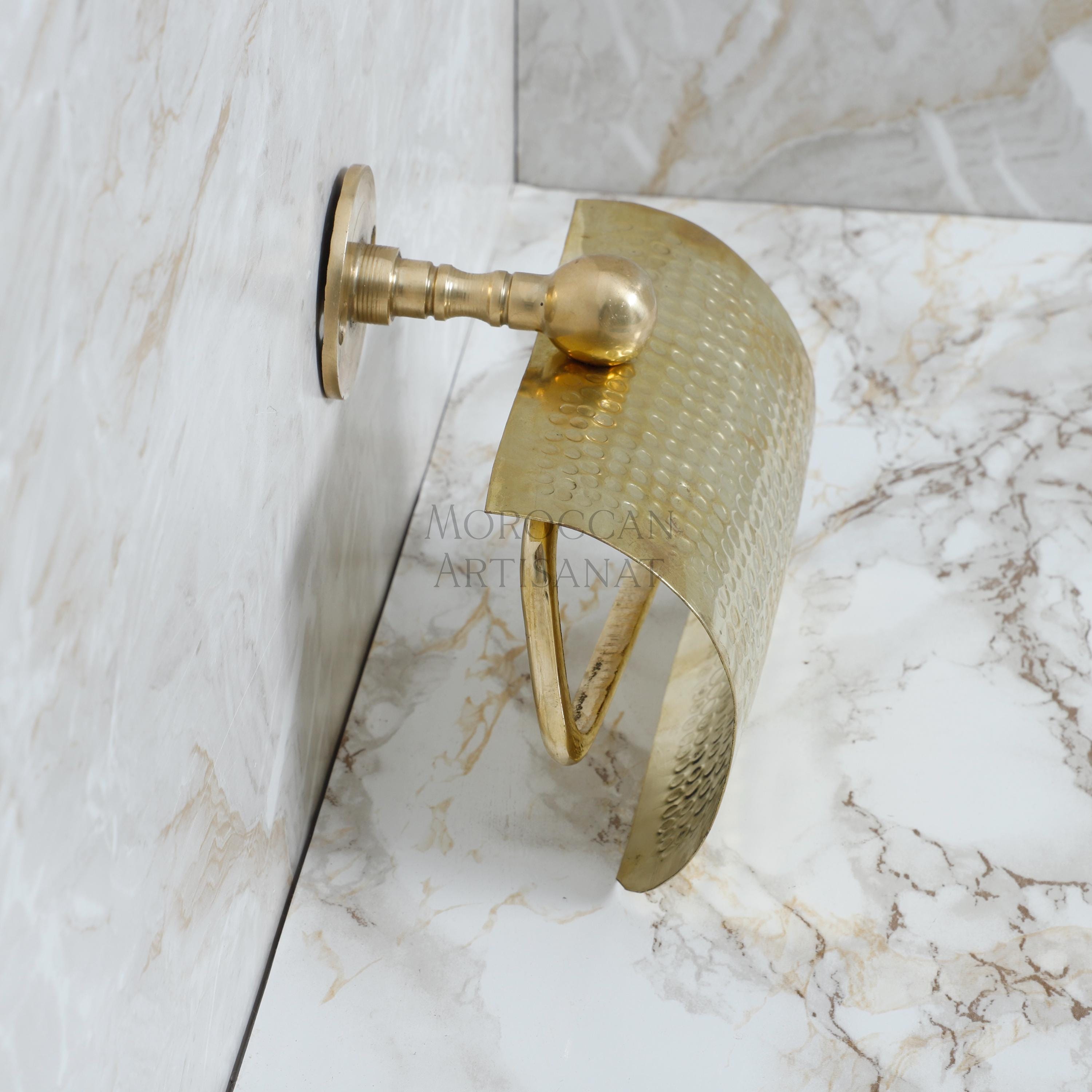 a close up of a bathroom faucet on a marble wall