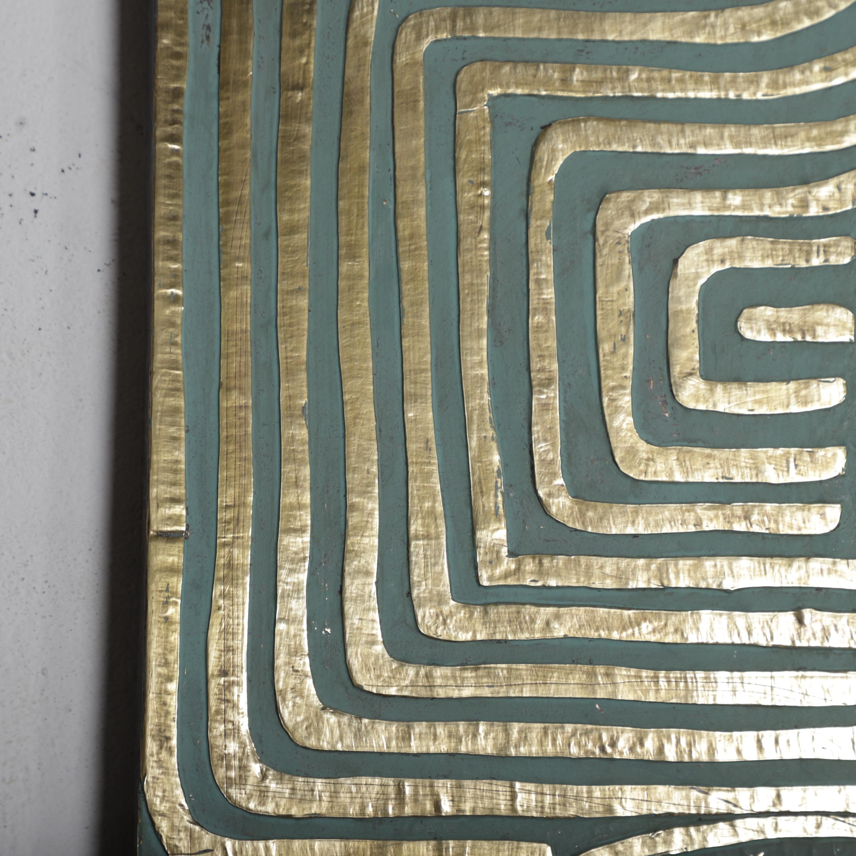 a close-up view of a textured surface with a repeating pattern of lines and swirls in shades of blue and gold.