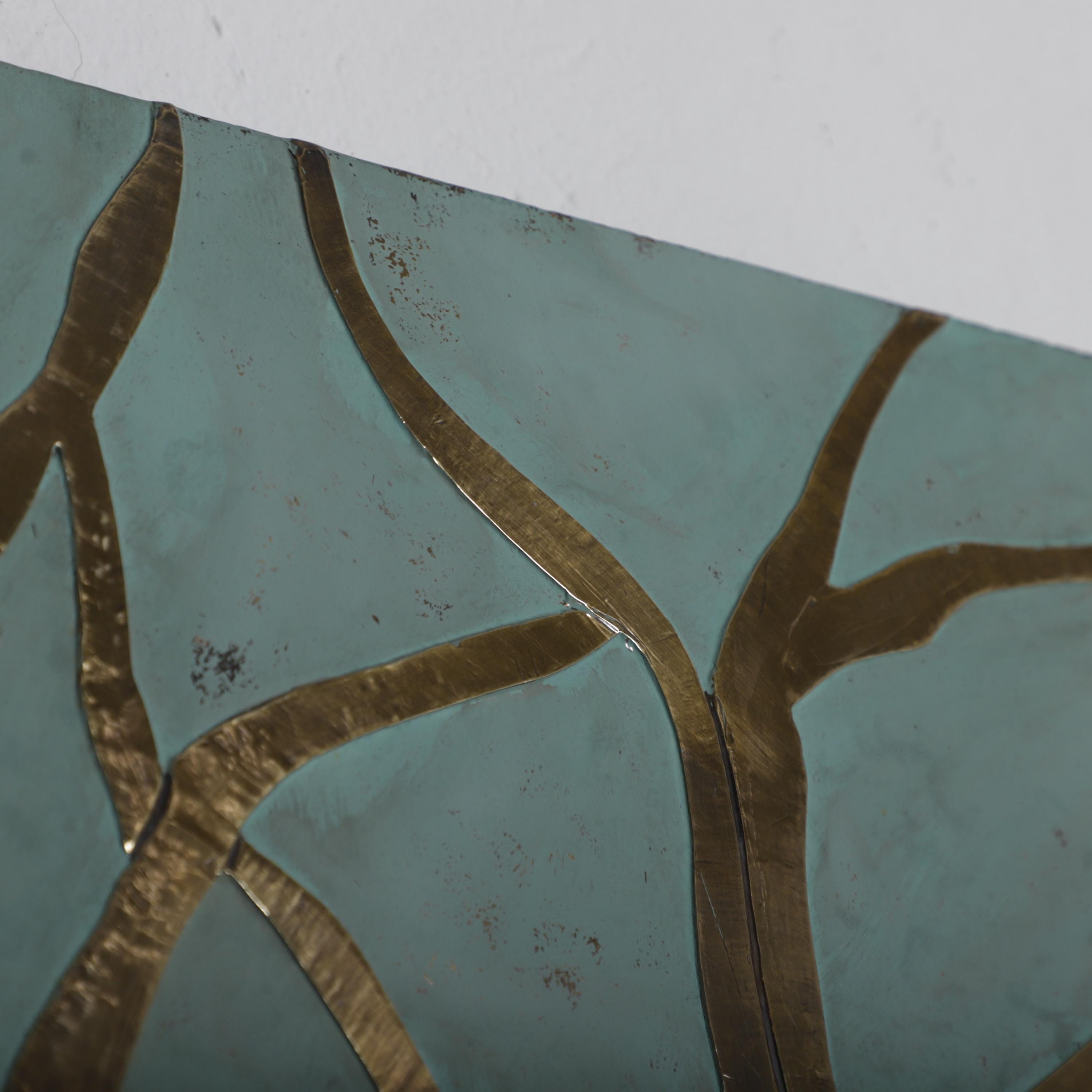 a close-up view of a textured surface with a pattern of intersecting lines in shades of blue and gold.