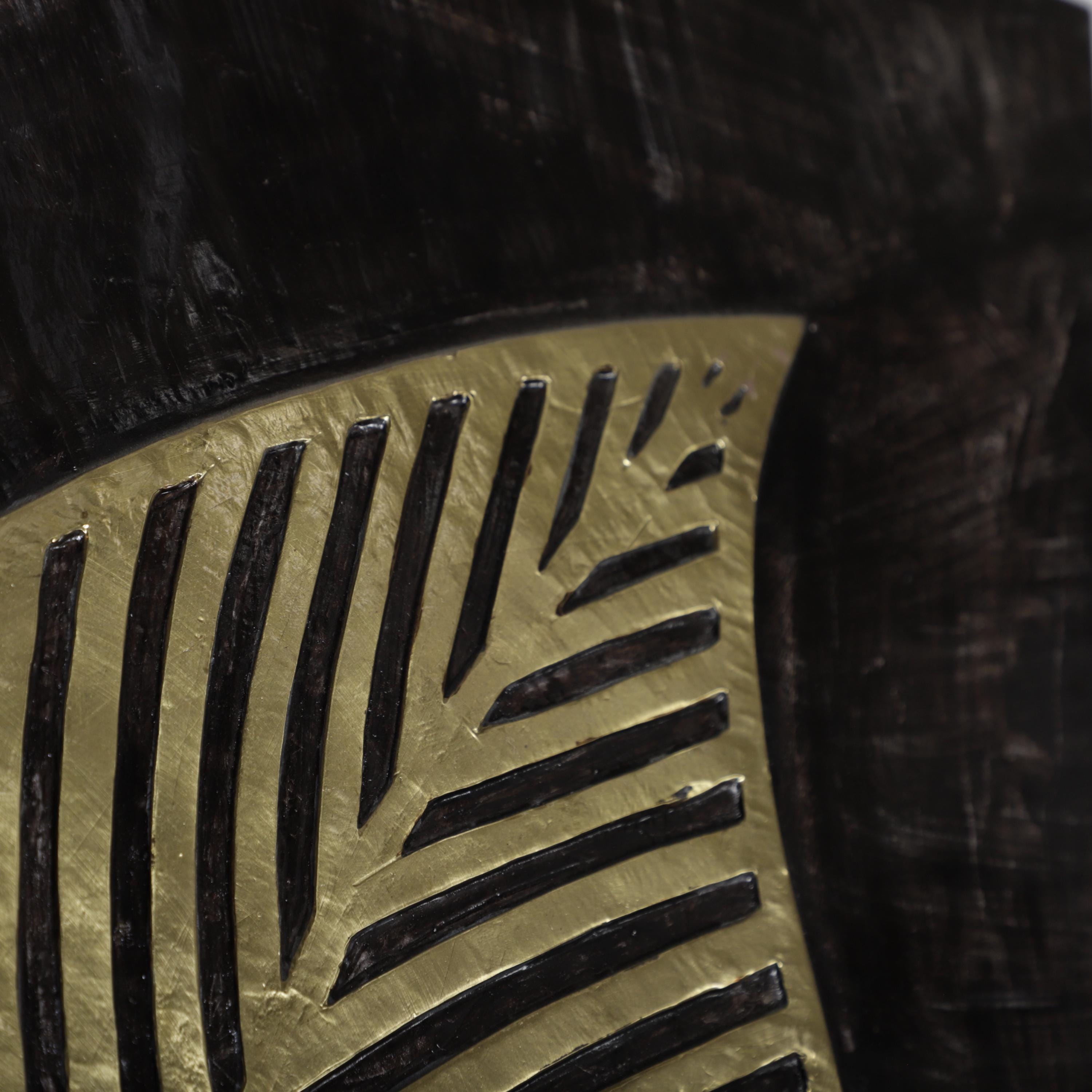 a close-up view of a striking black and gold design, with bold black lines and a golden background.