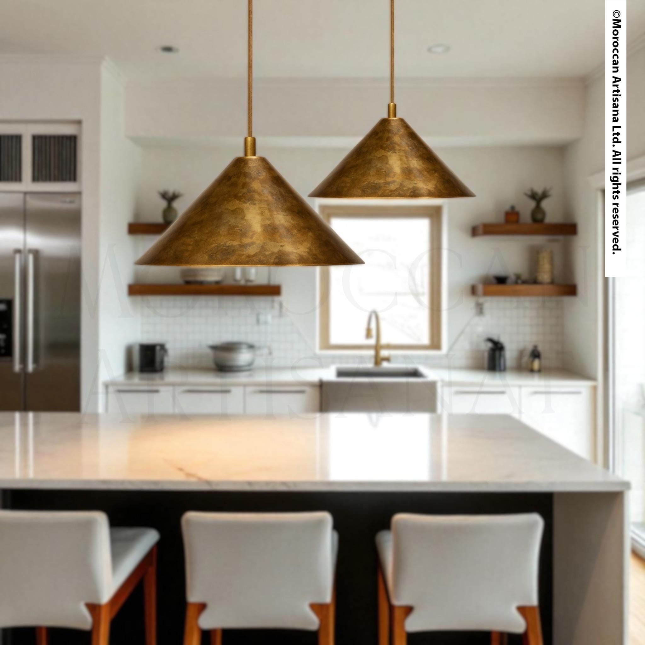 a modern kitchen with a large island, pendant lights, and white chairs.