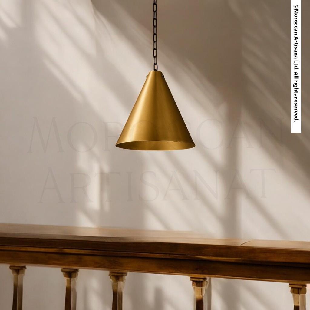 A gold-colored pendant light hangs from the ceiling, casting a shadow on the wall behind it.