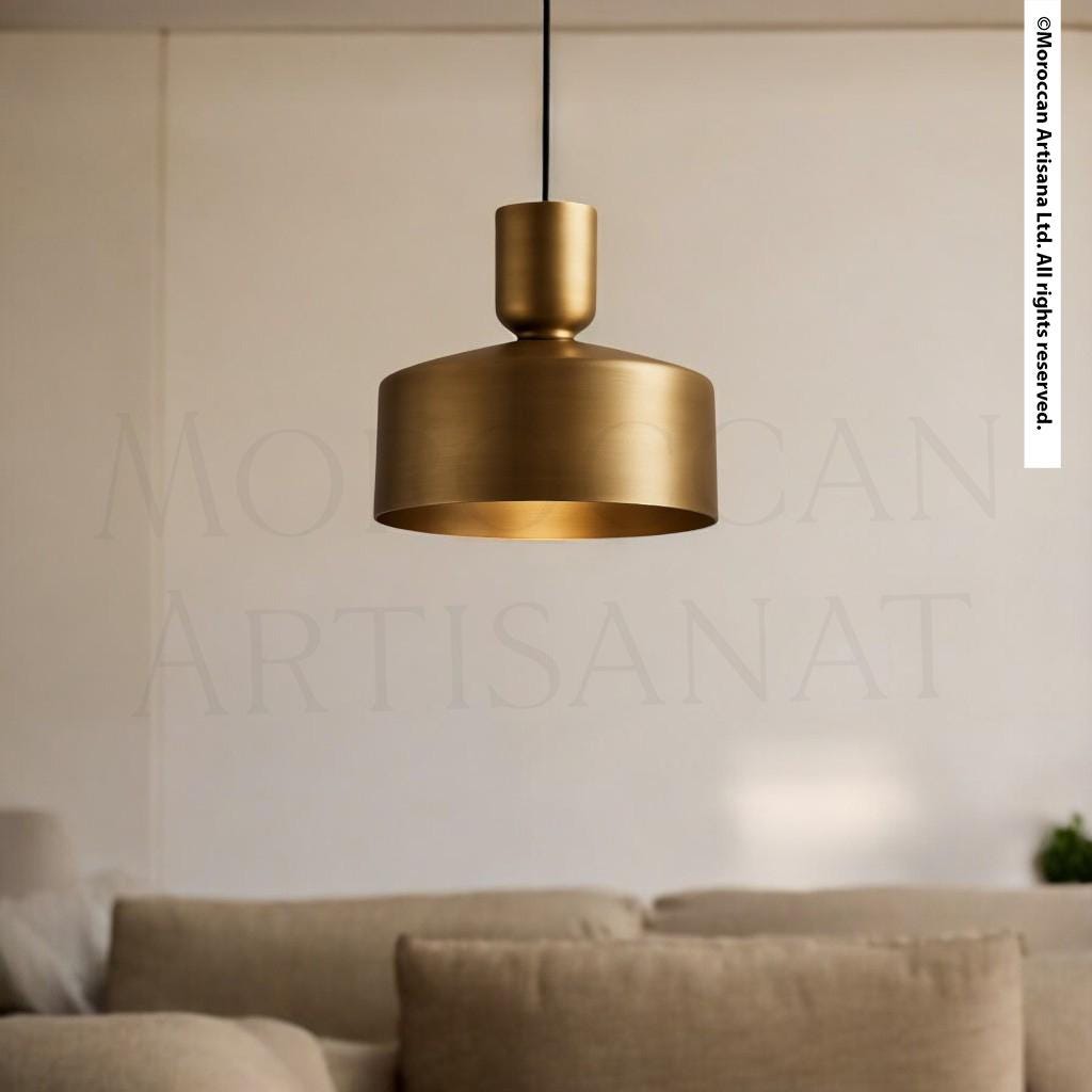 A gold-colored pendant light hangs from the ceiling in a living room, casting a warm glow over the space.
