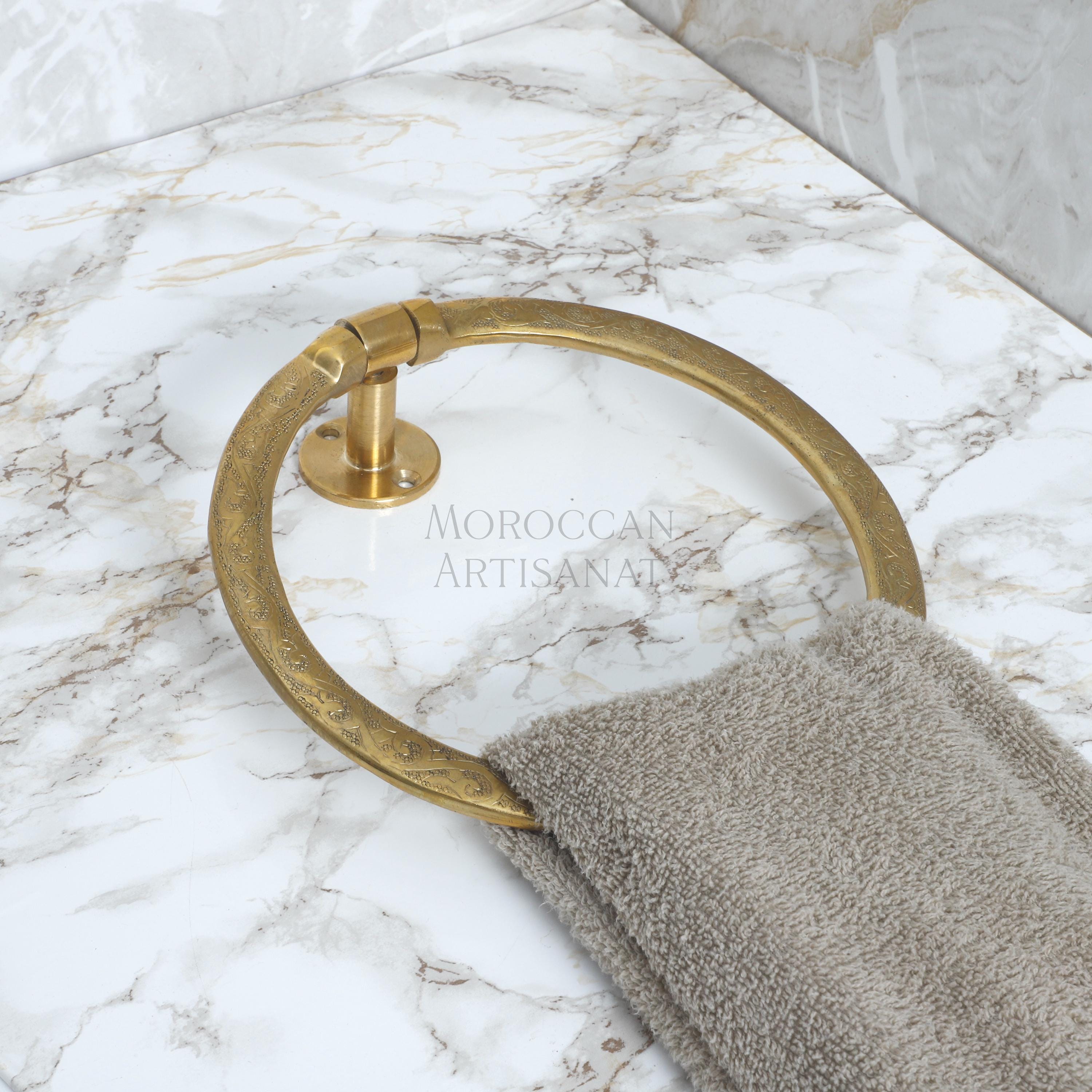 a marble counter top with a towel ring