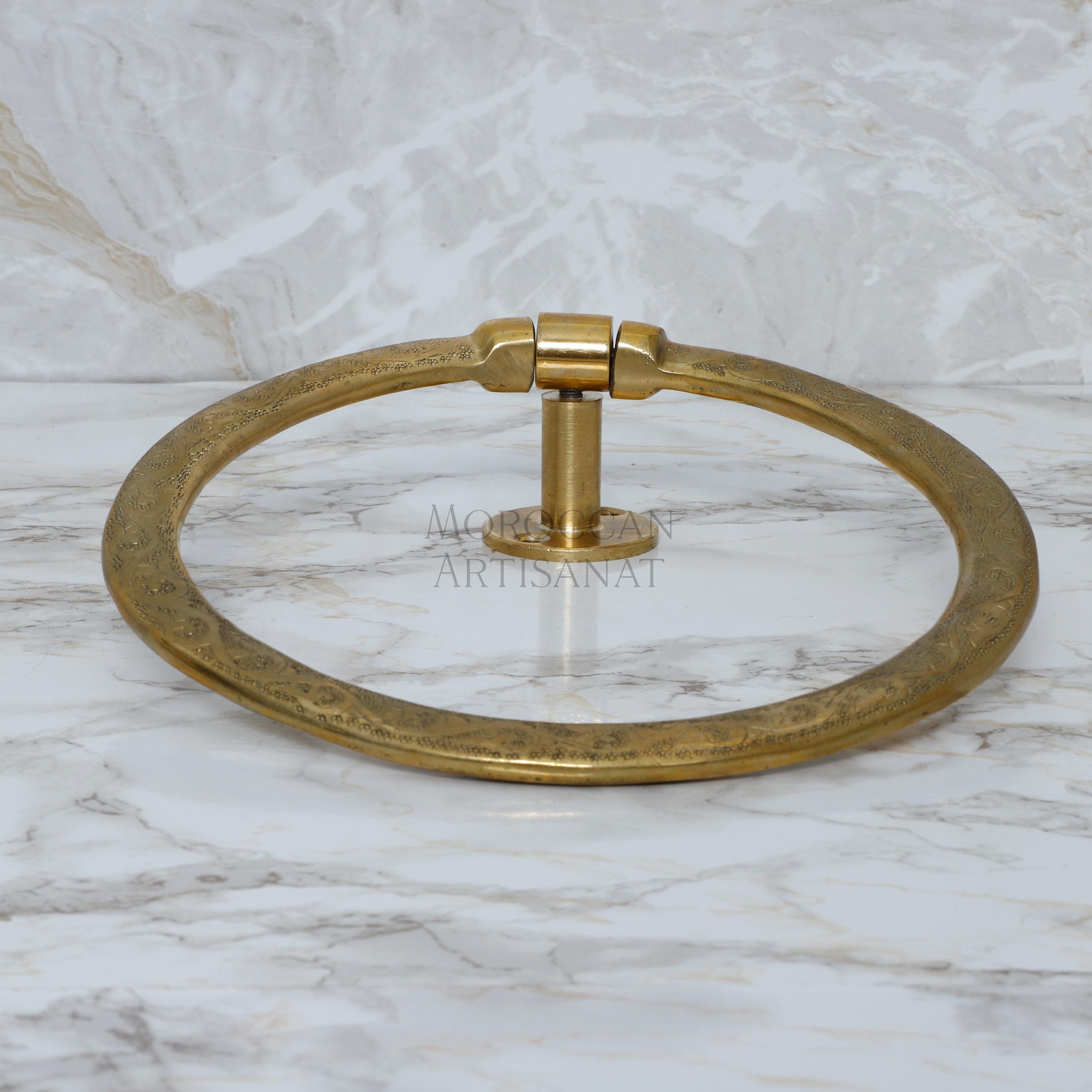 a brass towel ring on a marble counter