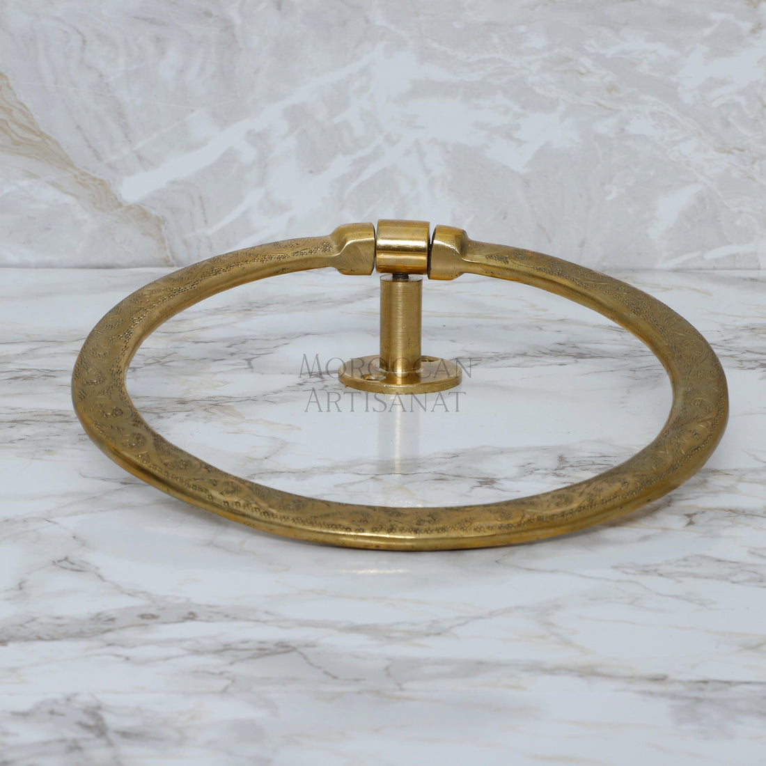 a brass towel ring on a marble counter
