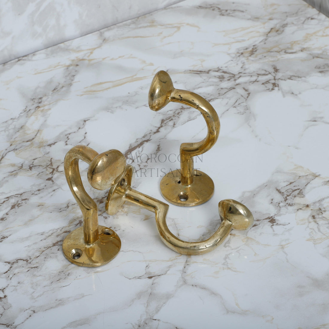 a pair of brass handles on a marble counter