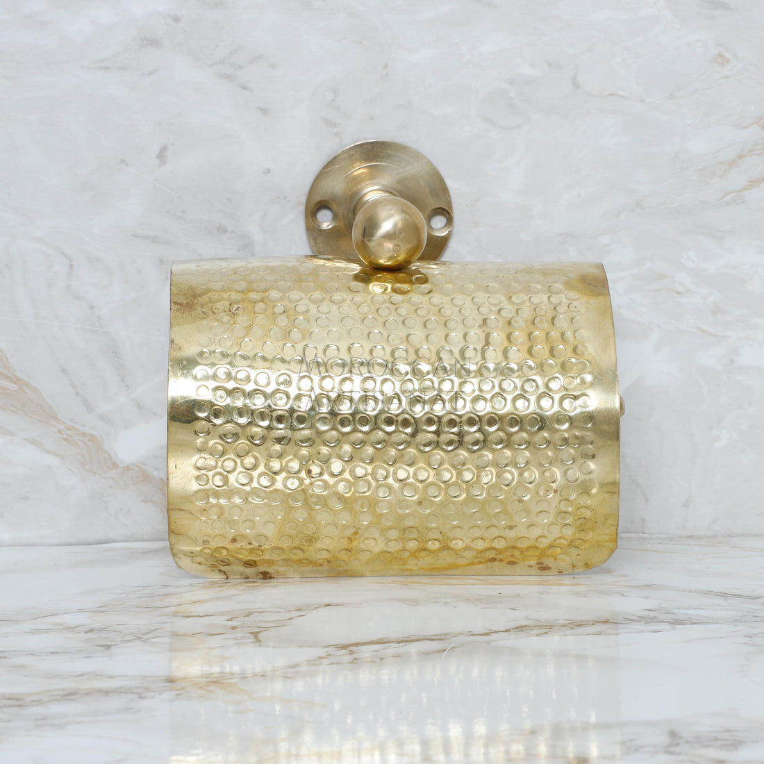 a gold purse sitting on top of a marble counter
