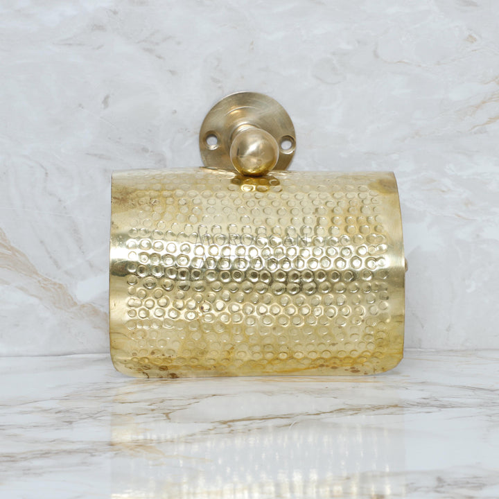 a gold purse sitting on top of a marble counter