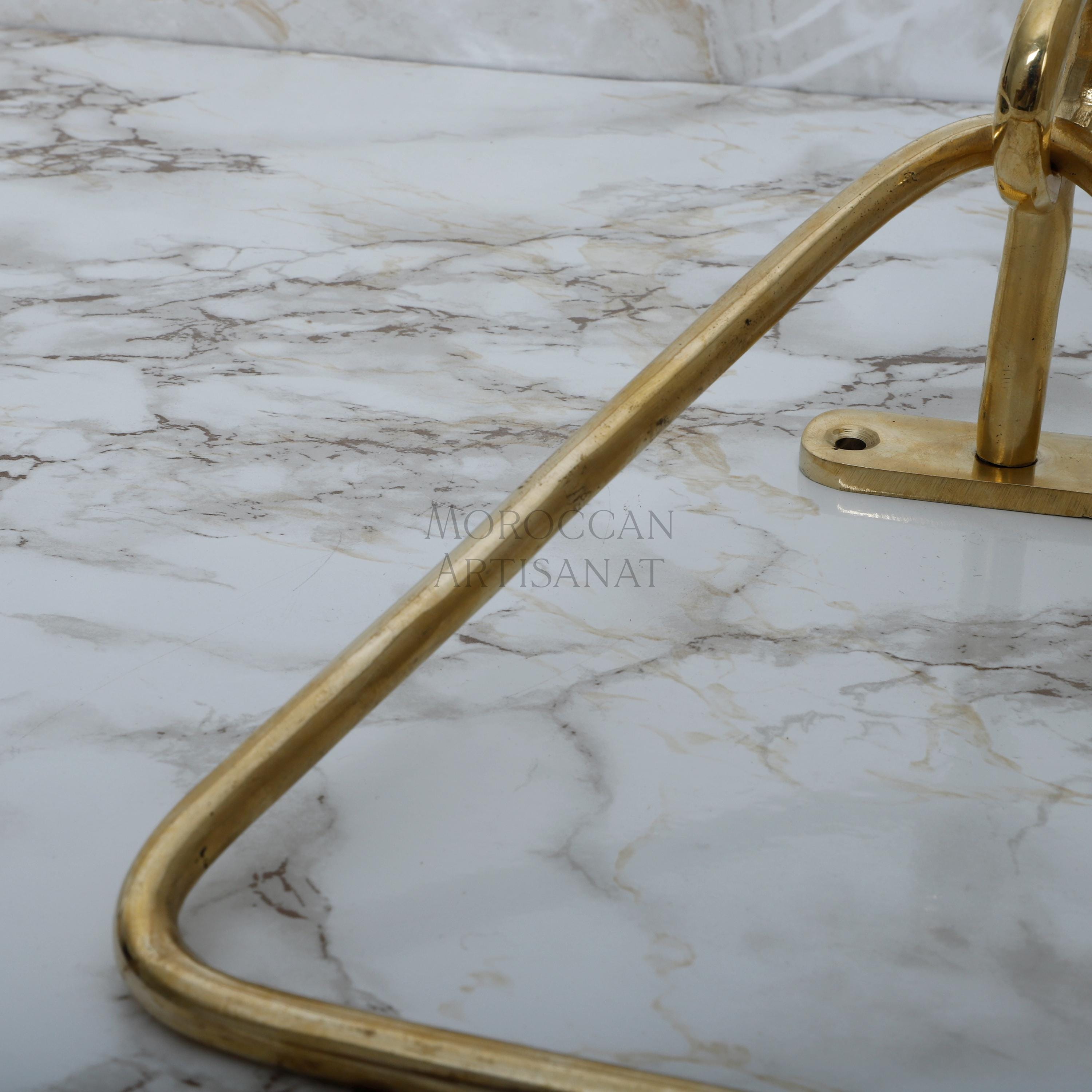 a marble counter top with a gold metal handle
