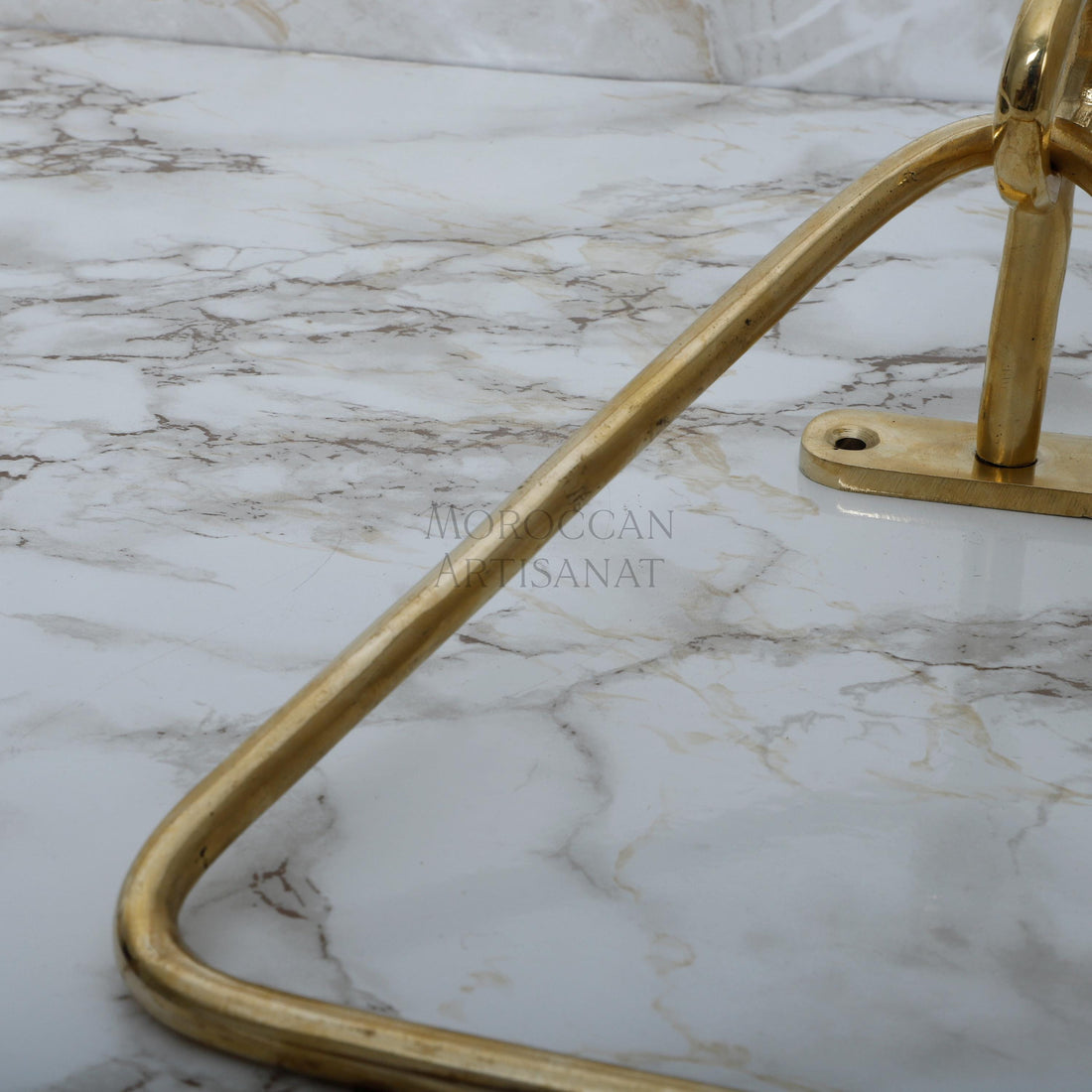 a marble counter top with a gold metal handle