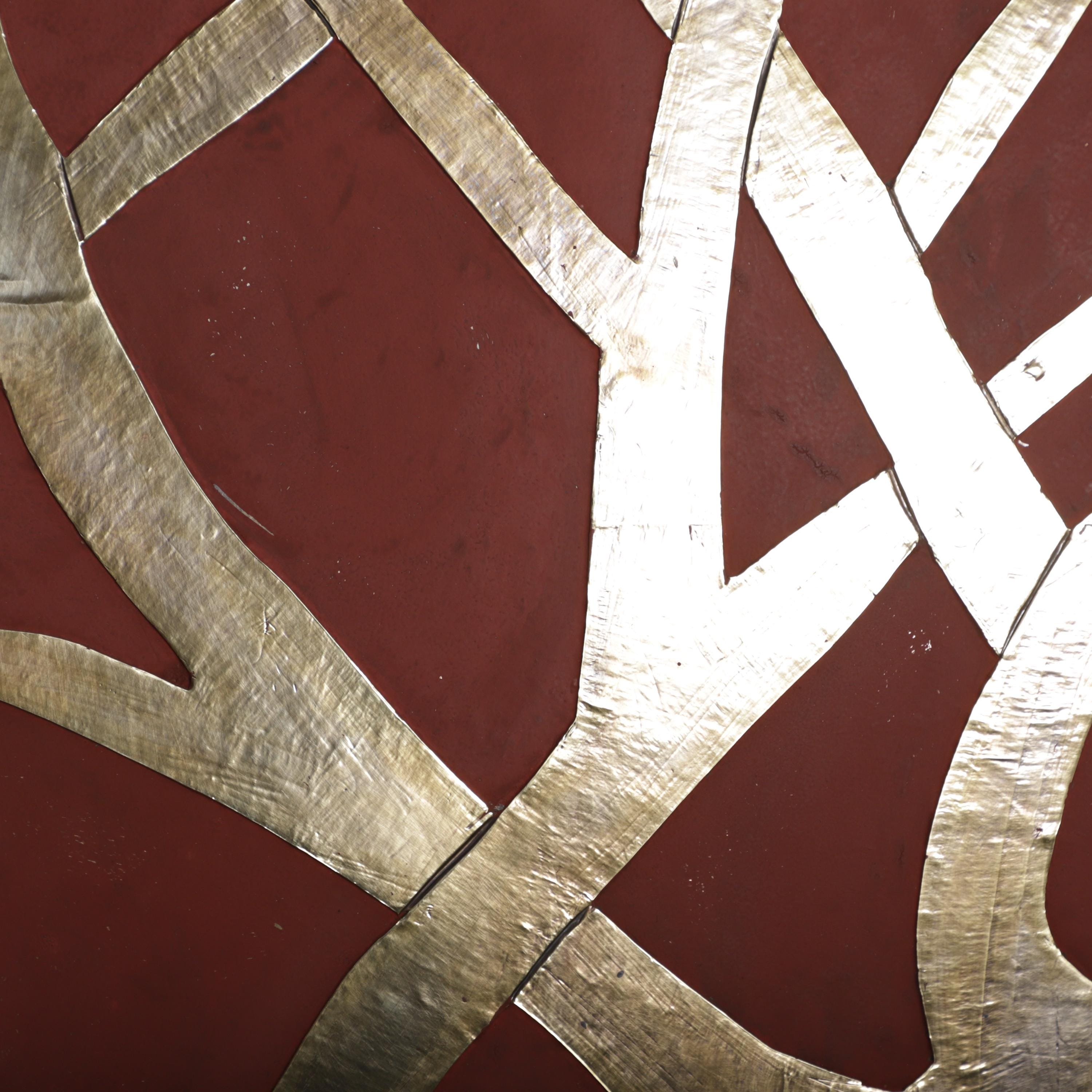 a close-up view of a metallic surface with a striking pattern of intersecting lines and shapes, creating a visually captivating and intricate design.