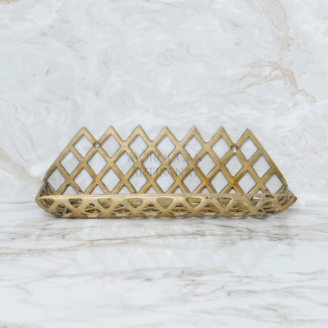 a golden metal object on a marble surface