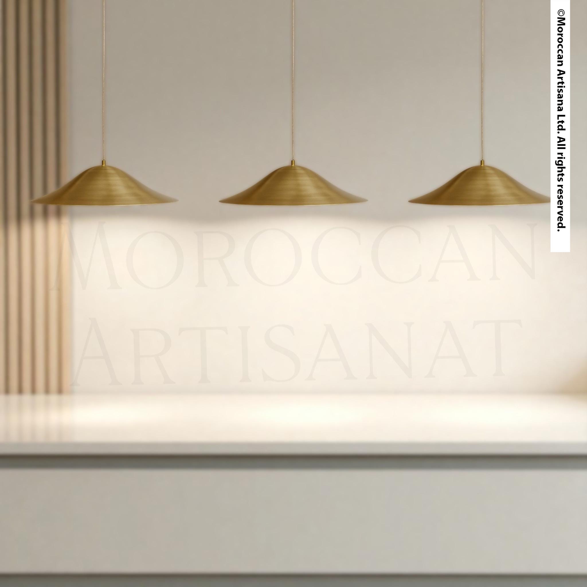 three hanging gold-colored pendant lights suspended from the ceiling.