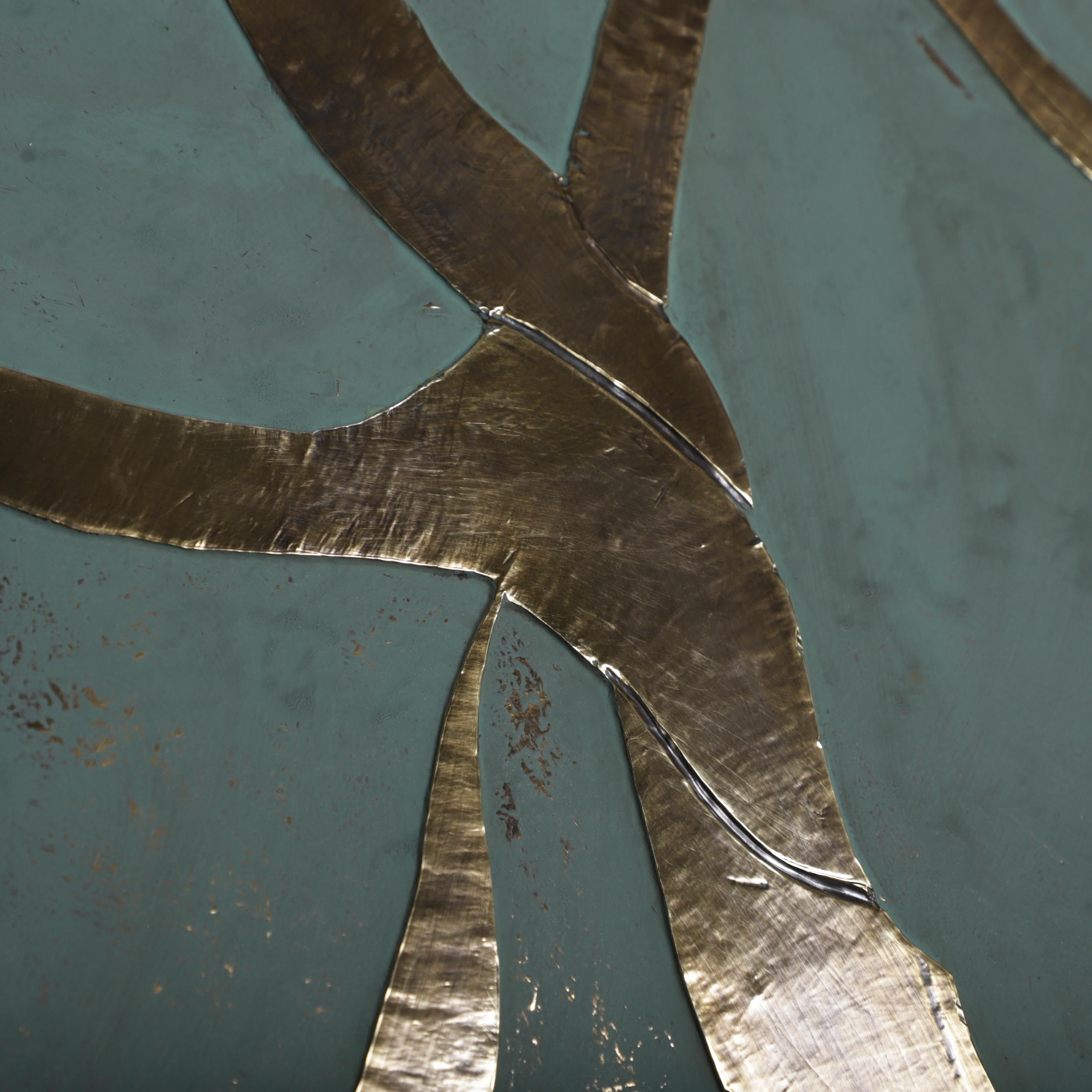 a close-up view of a metallic surface with a textured, metallic appearance. The surface appears to be a combination of green and gold colors, with a metallic sheen that gives it a unique and visually striking appearance.