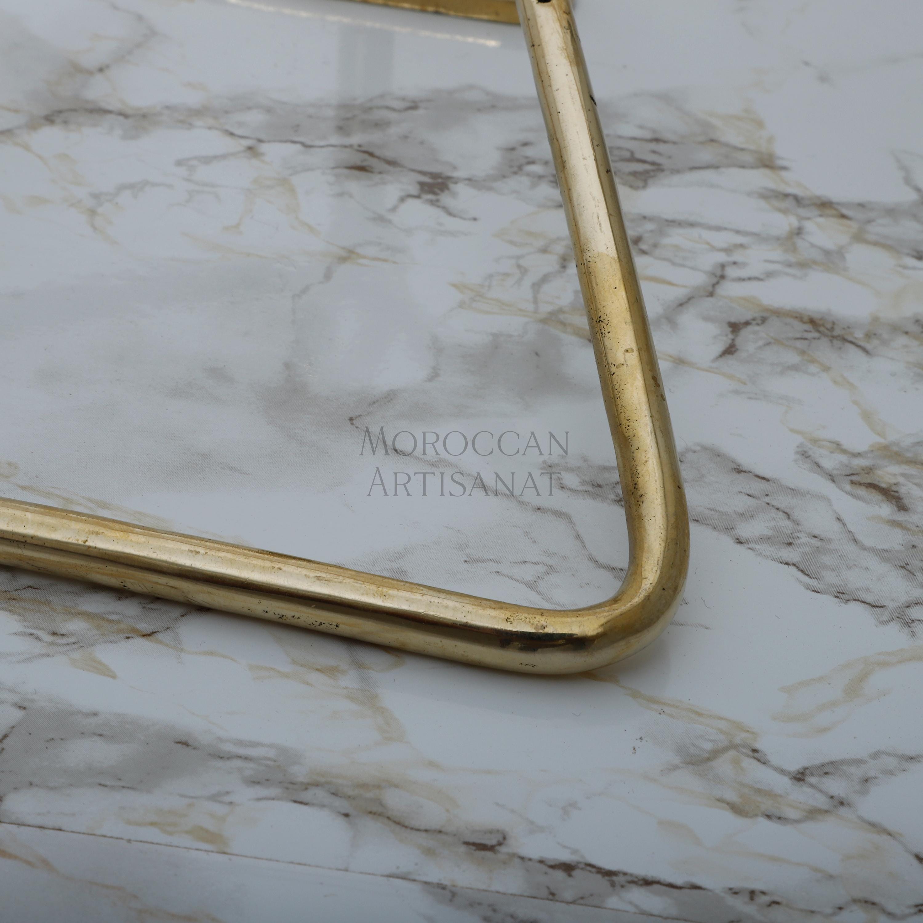 a marble table with a gold metal frame