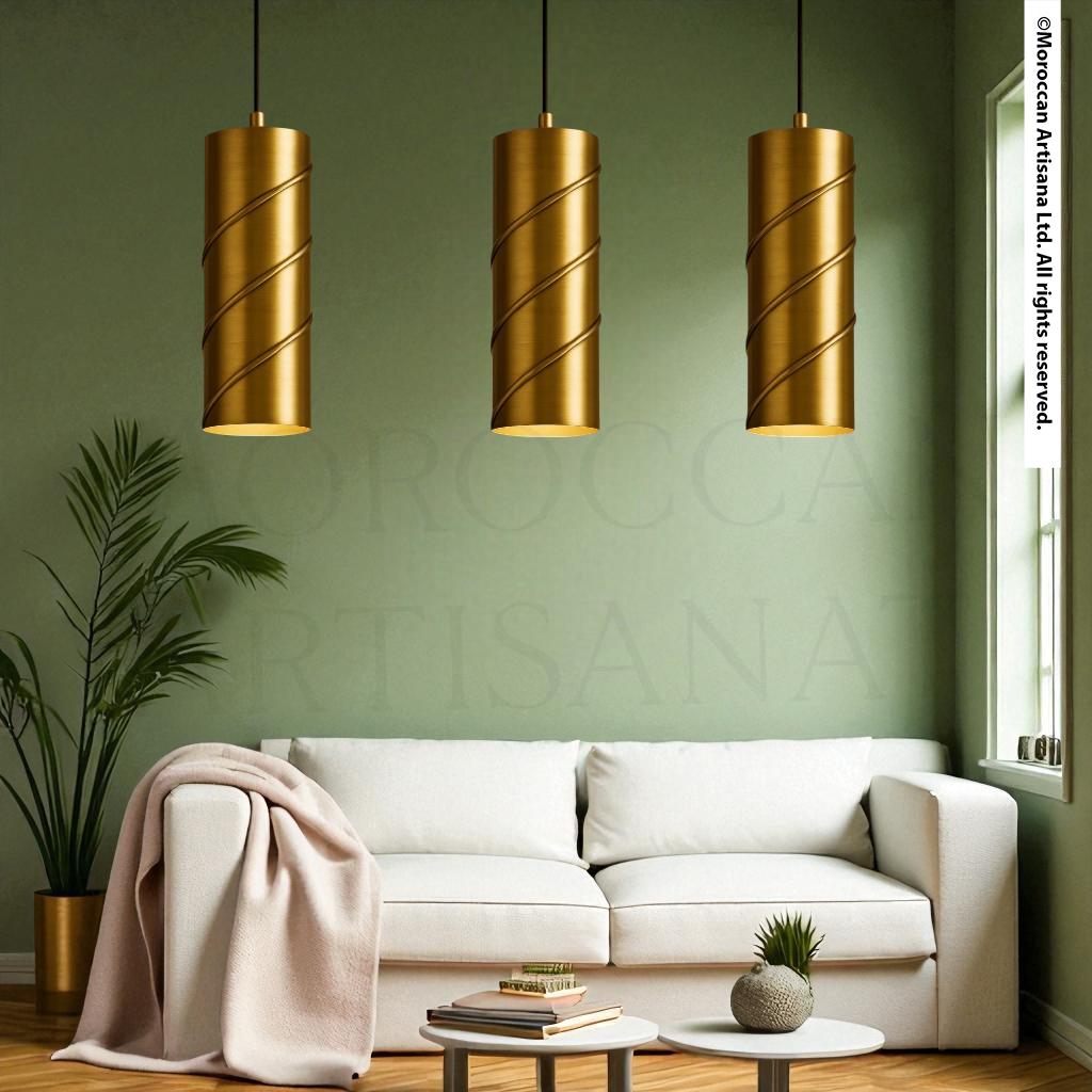 a modern living room with a white sofa, a potted plant, and three gold pendant lights hanging above the sofa.