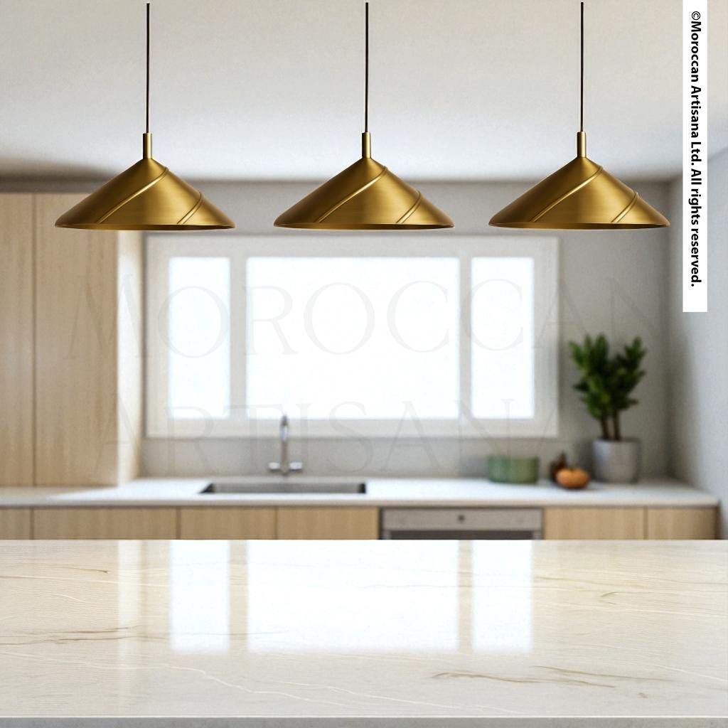 a modern kitchen with a marble countertop, three pendant lights hanging above it, and a window providing natural light.