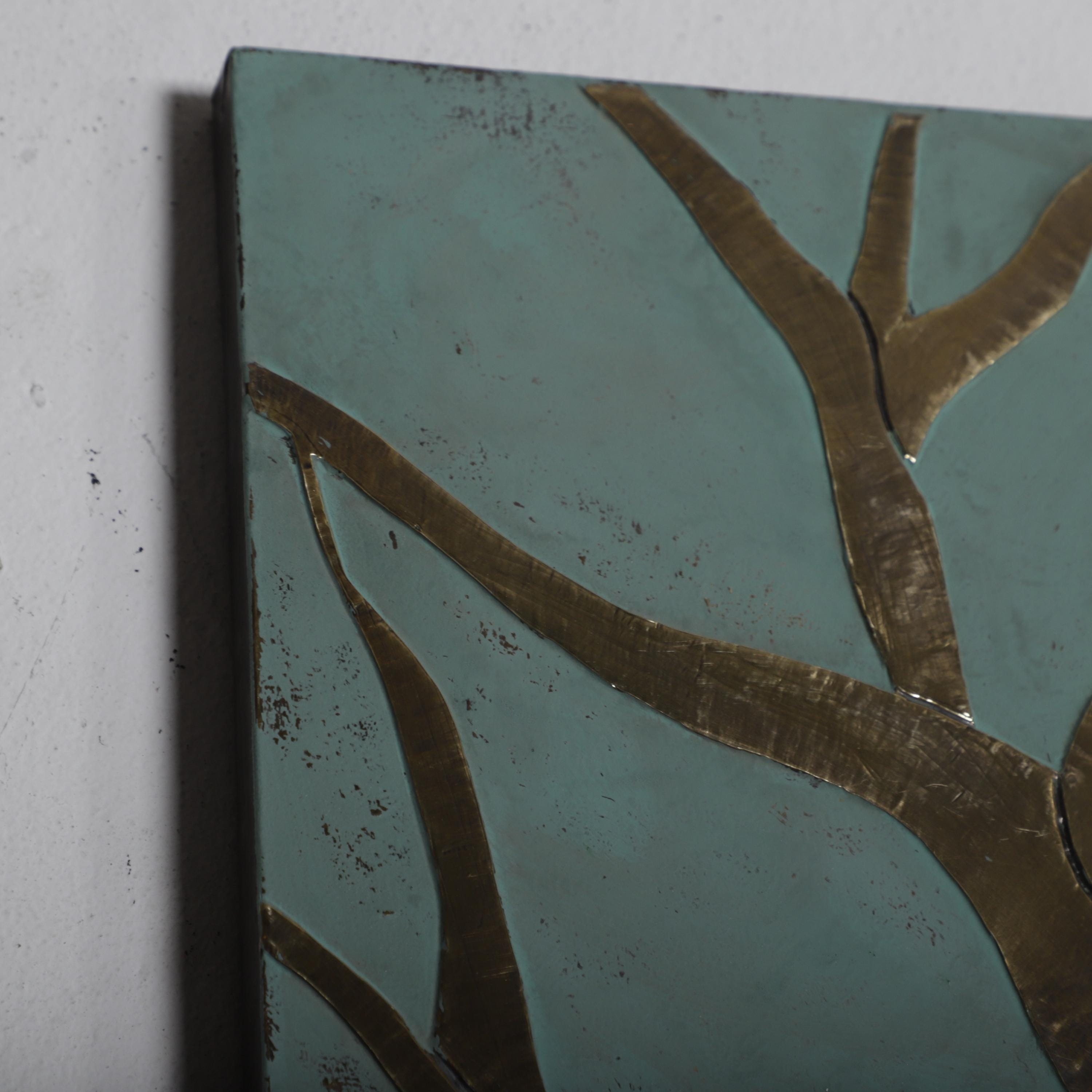 a close-up view of a piece of art, possibly a painting or sculpture, with a dark green background and a pattern of thin, curved lines or branches.