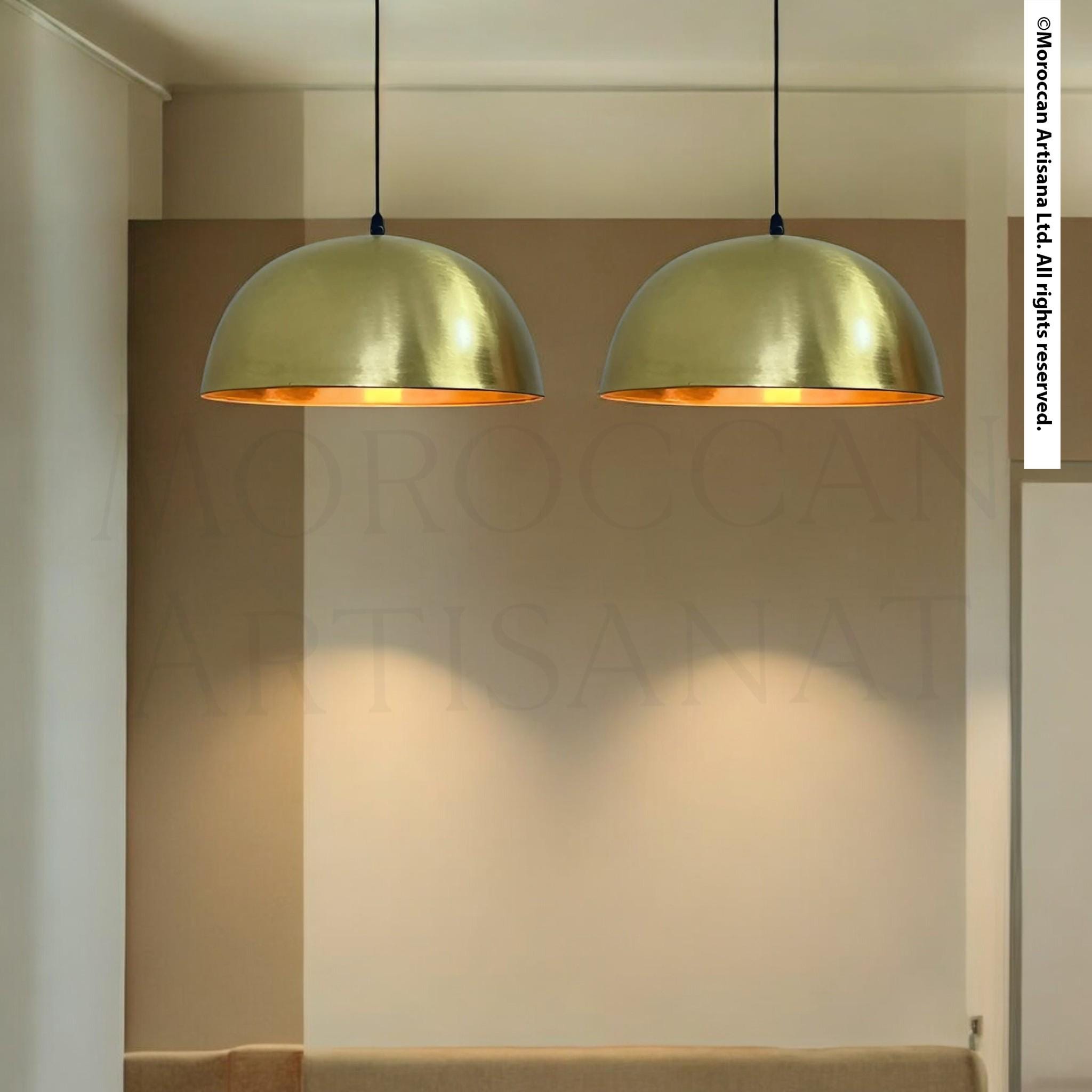 two gold-colored pendant lights hanging from the ceiling, casting a warm glow in the room.