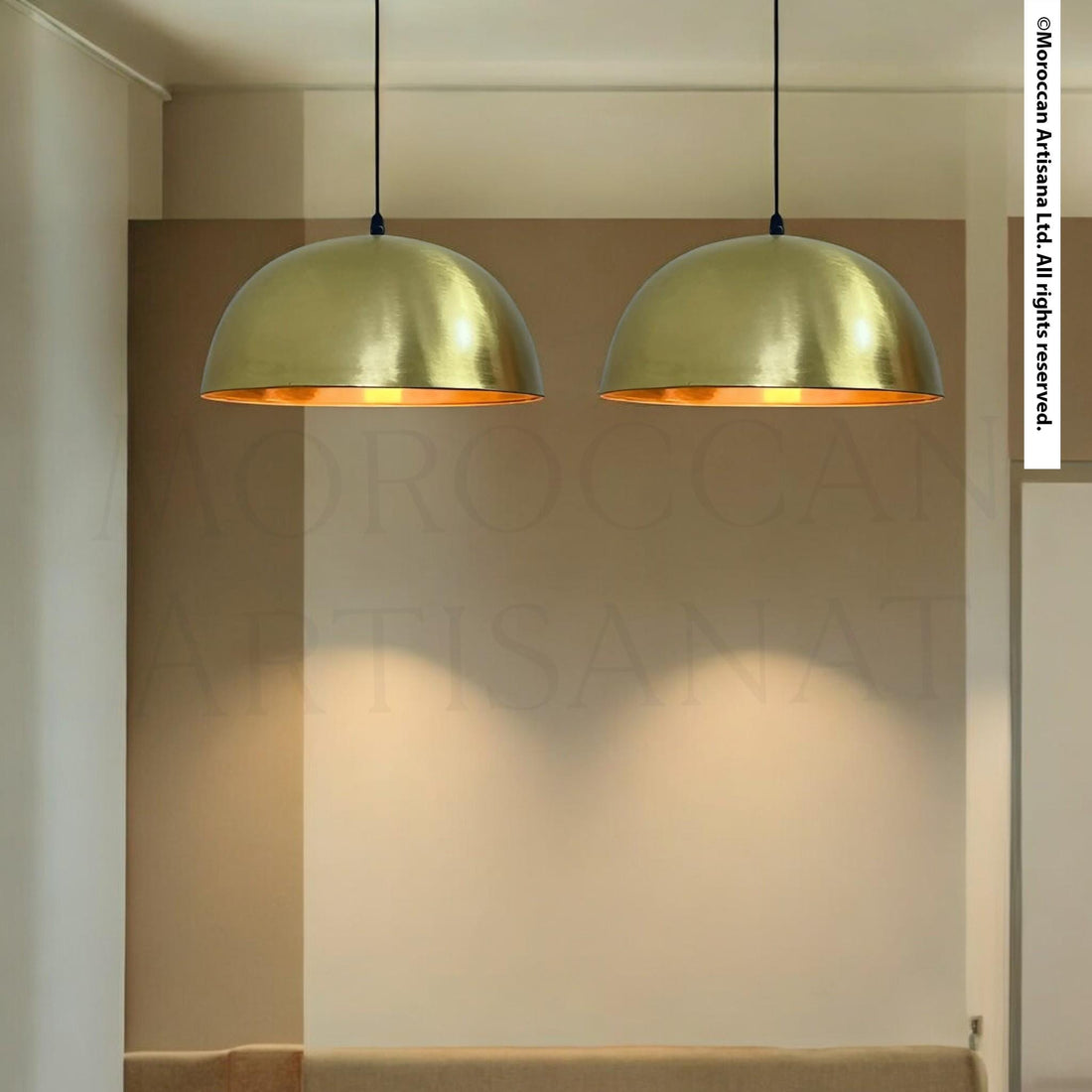 two gold-colored pendant lights hanging from the ceiling, casting a warm glow in the room.