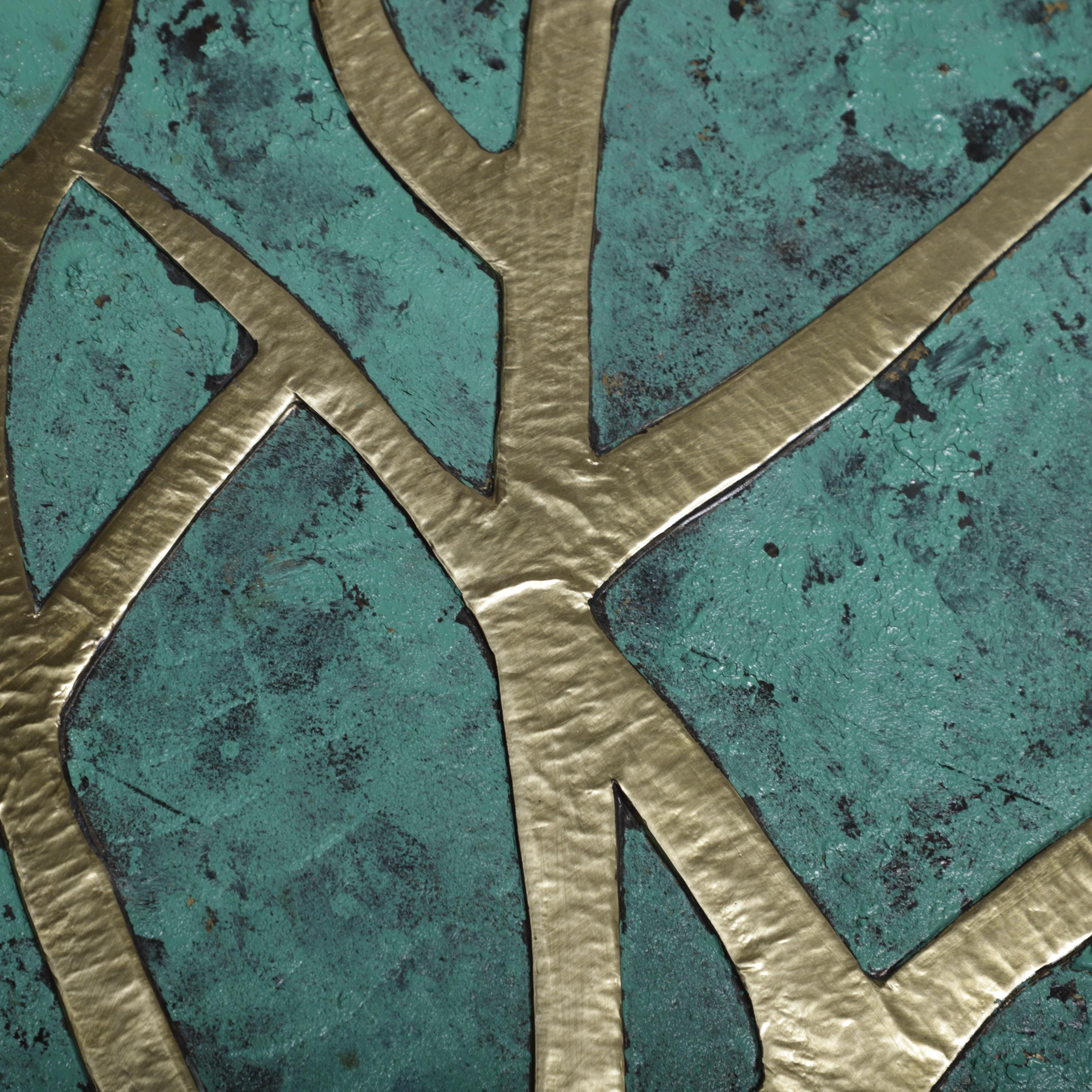 a close-up view of a textured surface with a metallic gold pattern. The pattern consists of intersecting lines and shapes, creating a visually striking contrast against the turquoise background.