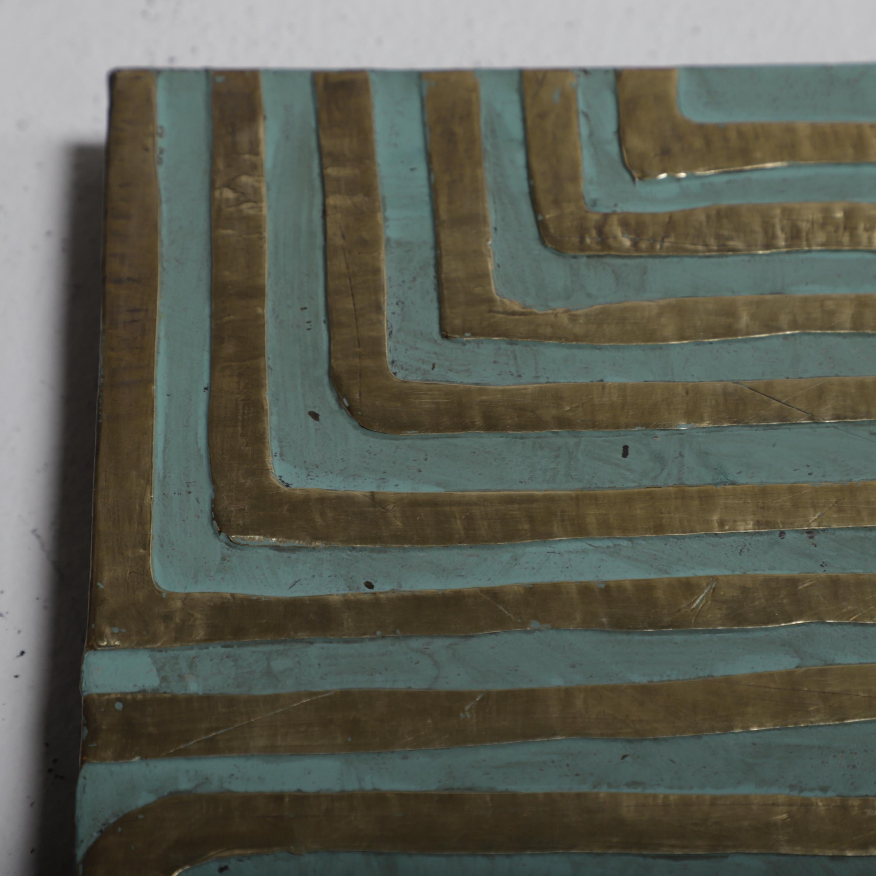 a close-up view of a textured surface with a repeating pattern of intersecting lines in shades of blue and gold.