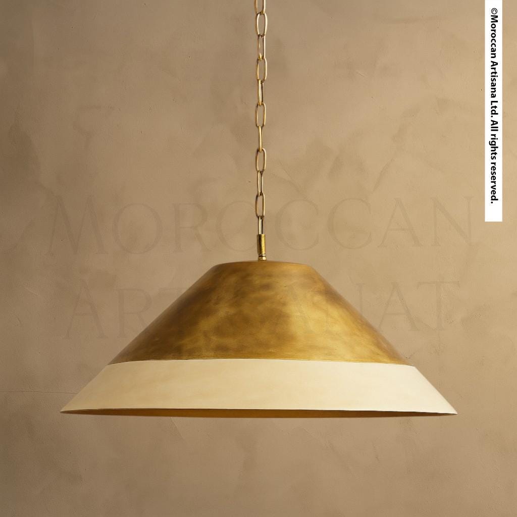 A gold-colored pendant light fixture with a cream-colored shade hangs from the ceiling.