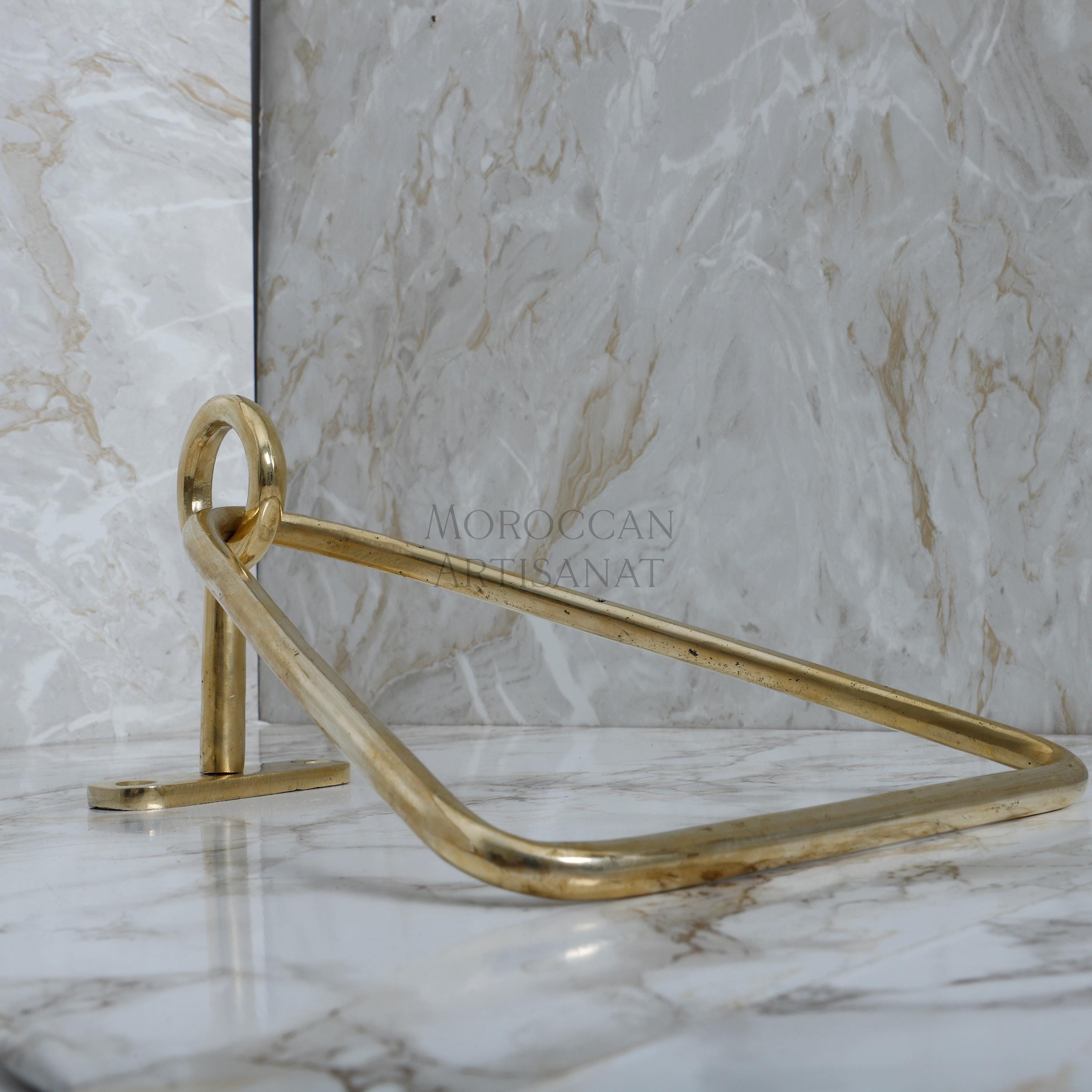 a marble counter top with a gold metal handle
