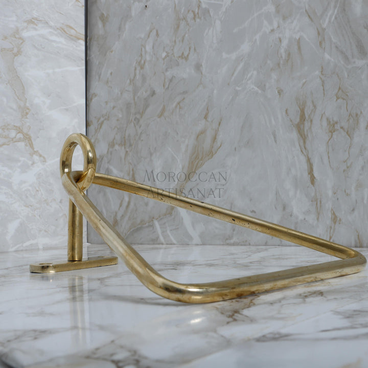 a marble counter top with a gold metal handle