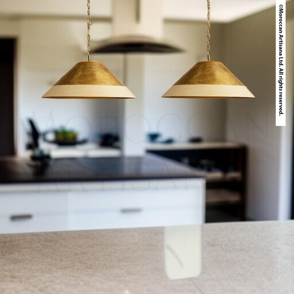 a modern kitchen with two pendant lights hanging above a countertop.