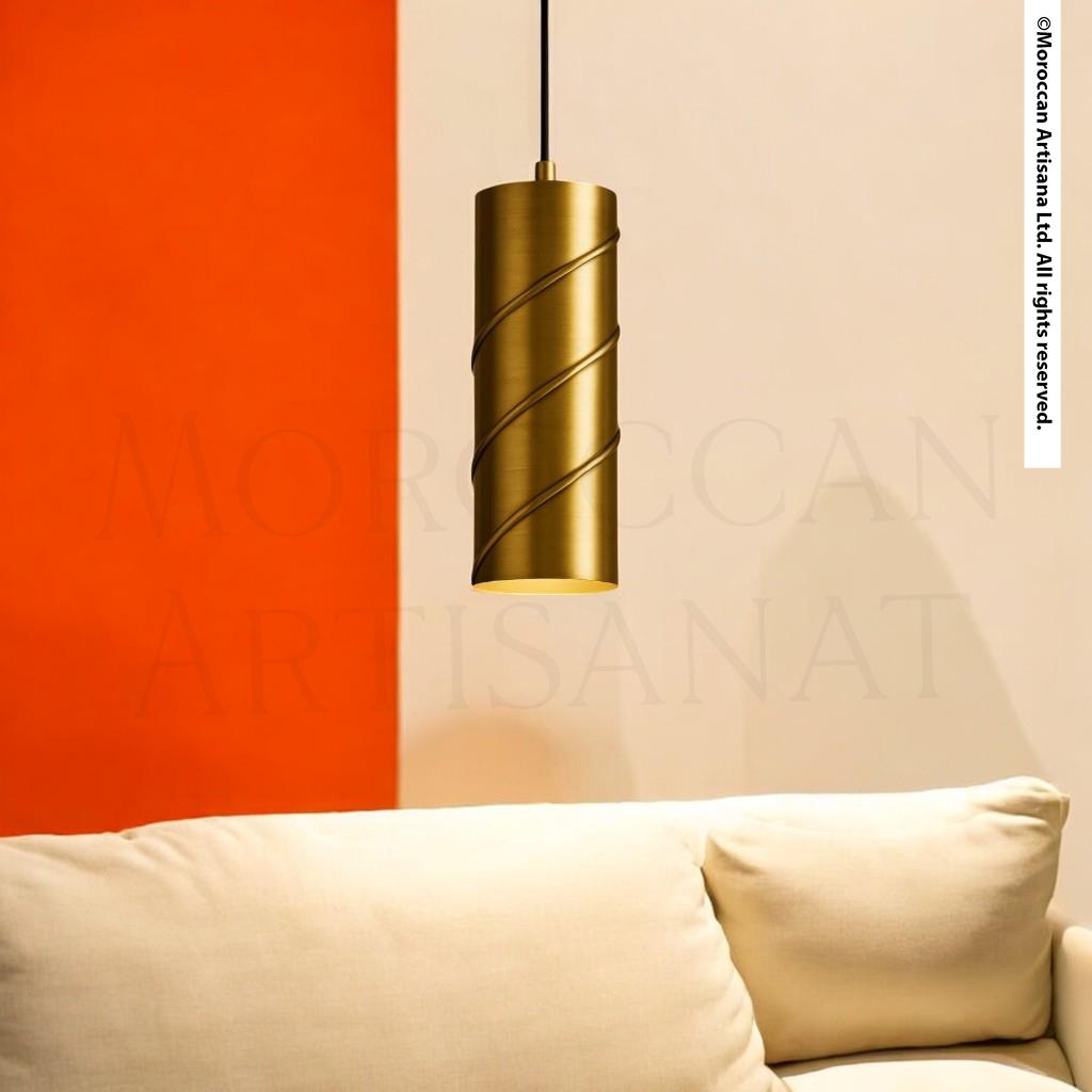 a modern, minimalist living room with a gold pendant lamp hanging from the ceiling, casting a warm glow over the white sofa.