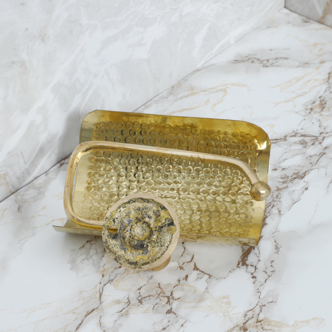a gold tray with a marble background