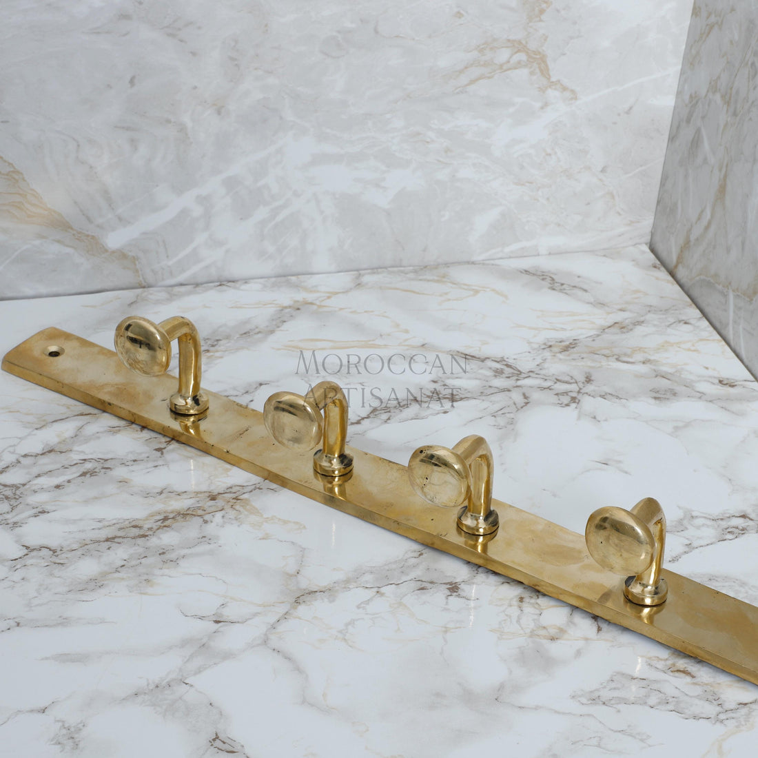 a marble counter top with brass handles on it