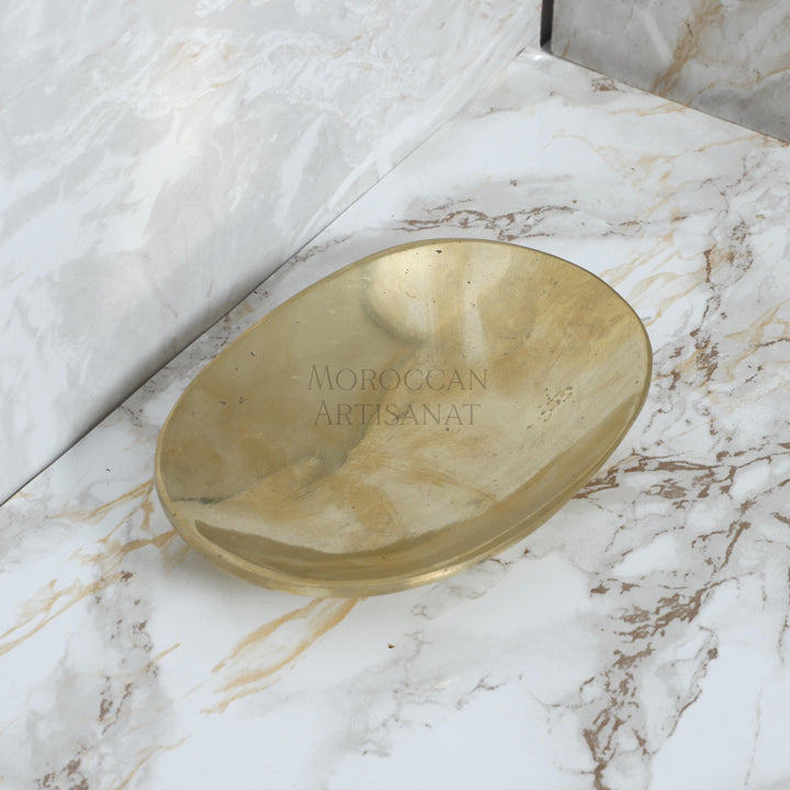 a gold plate sitting on top of a marble counter