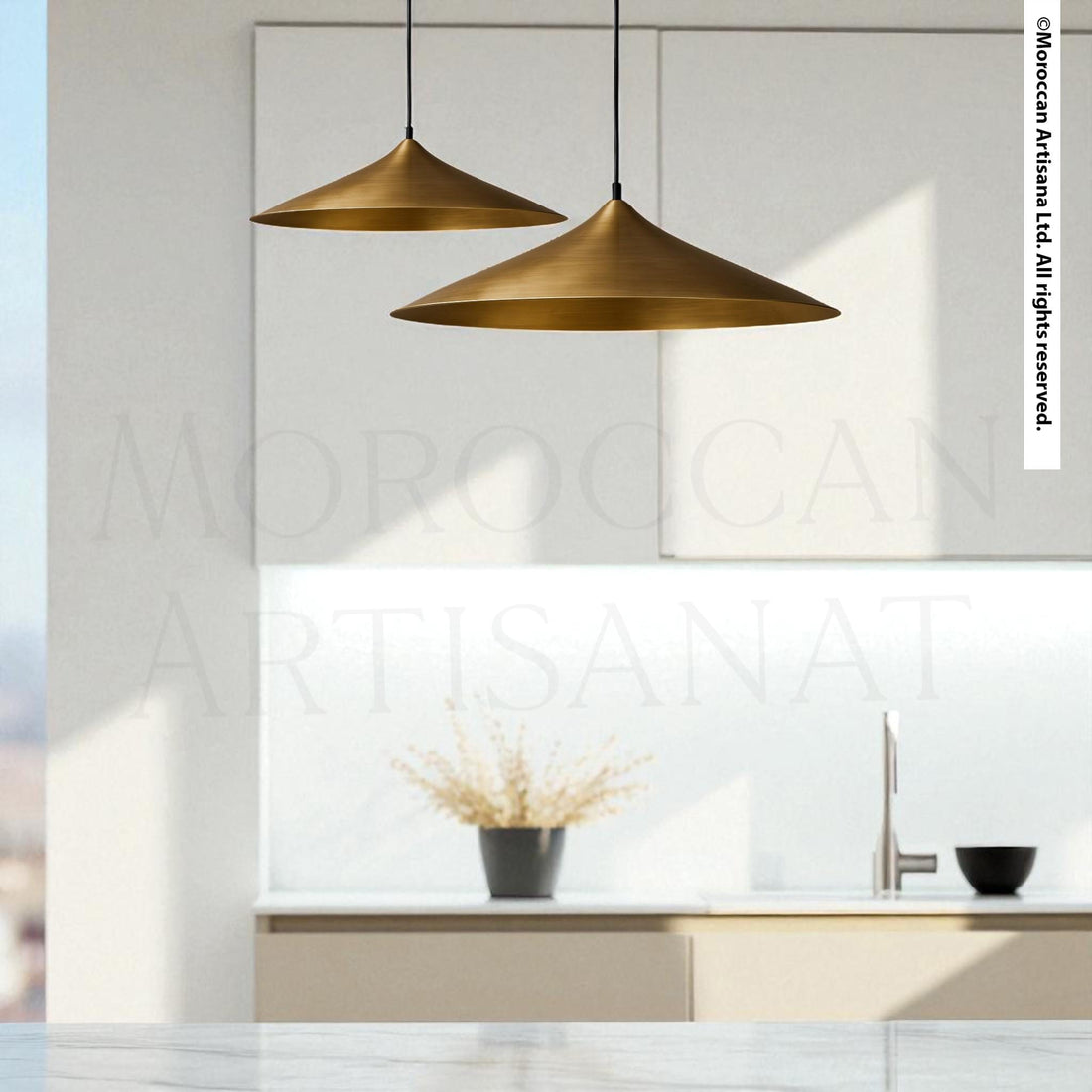 a modern kitchen with a minimalist design, featuring two pendant lights hanging above a countertop with a vase of flowers and a bowl on it.