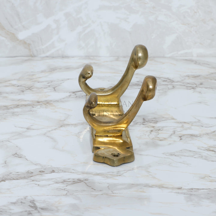 a golden metal object on a marble surface