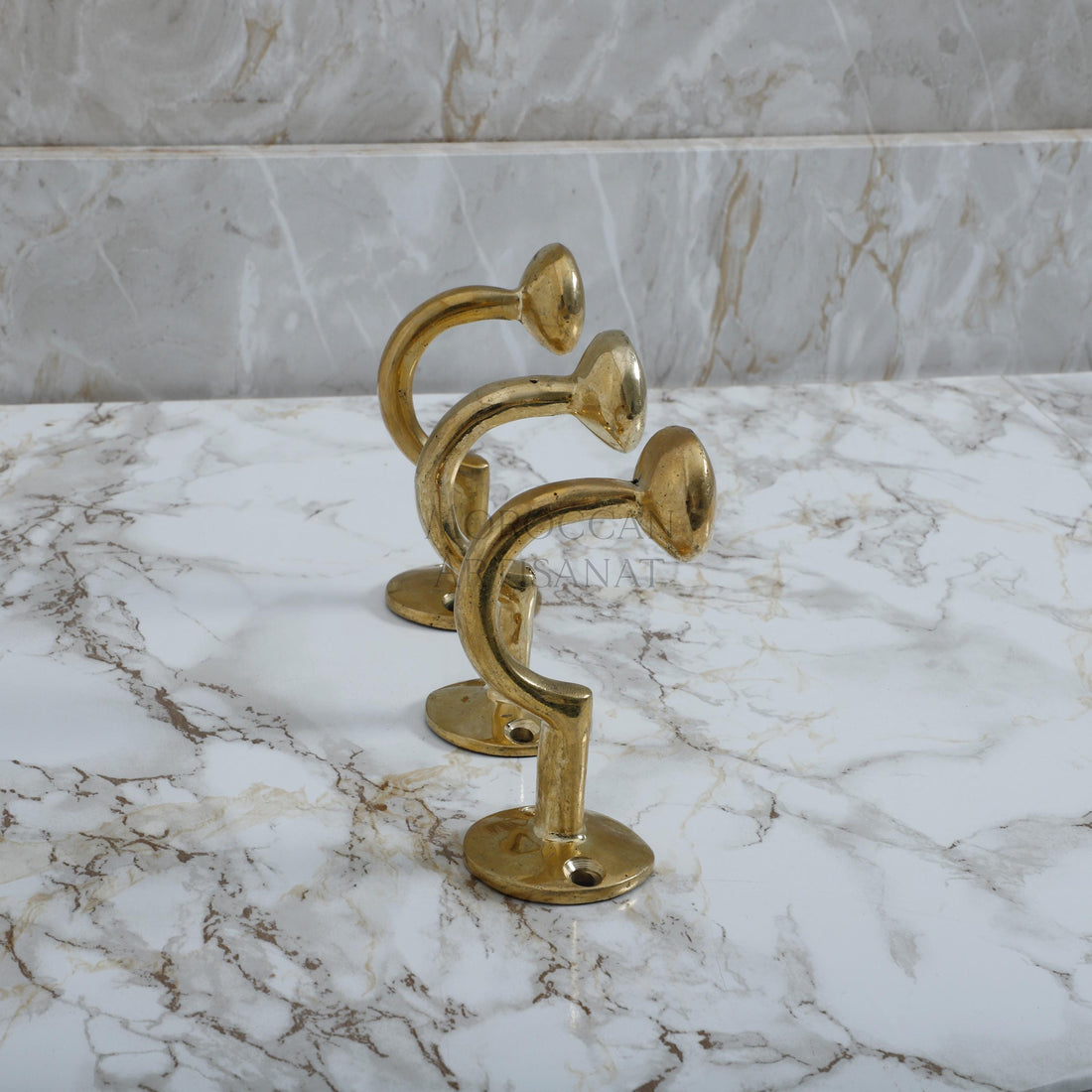 a marble counter top with a golden metal object on it