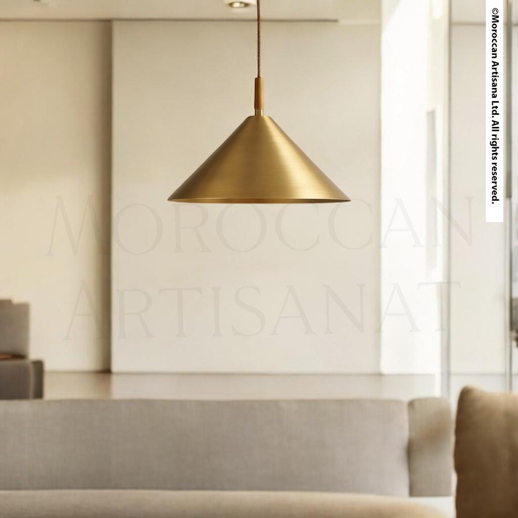 a modern living room with a gold pendant lamp hanging from the ceiling, casting a warm glow over the space.