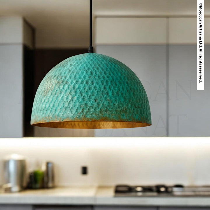 A modern kitchen with a green pendant light hanging above a countertop.