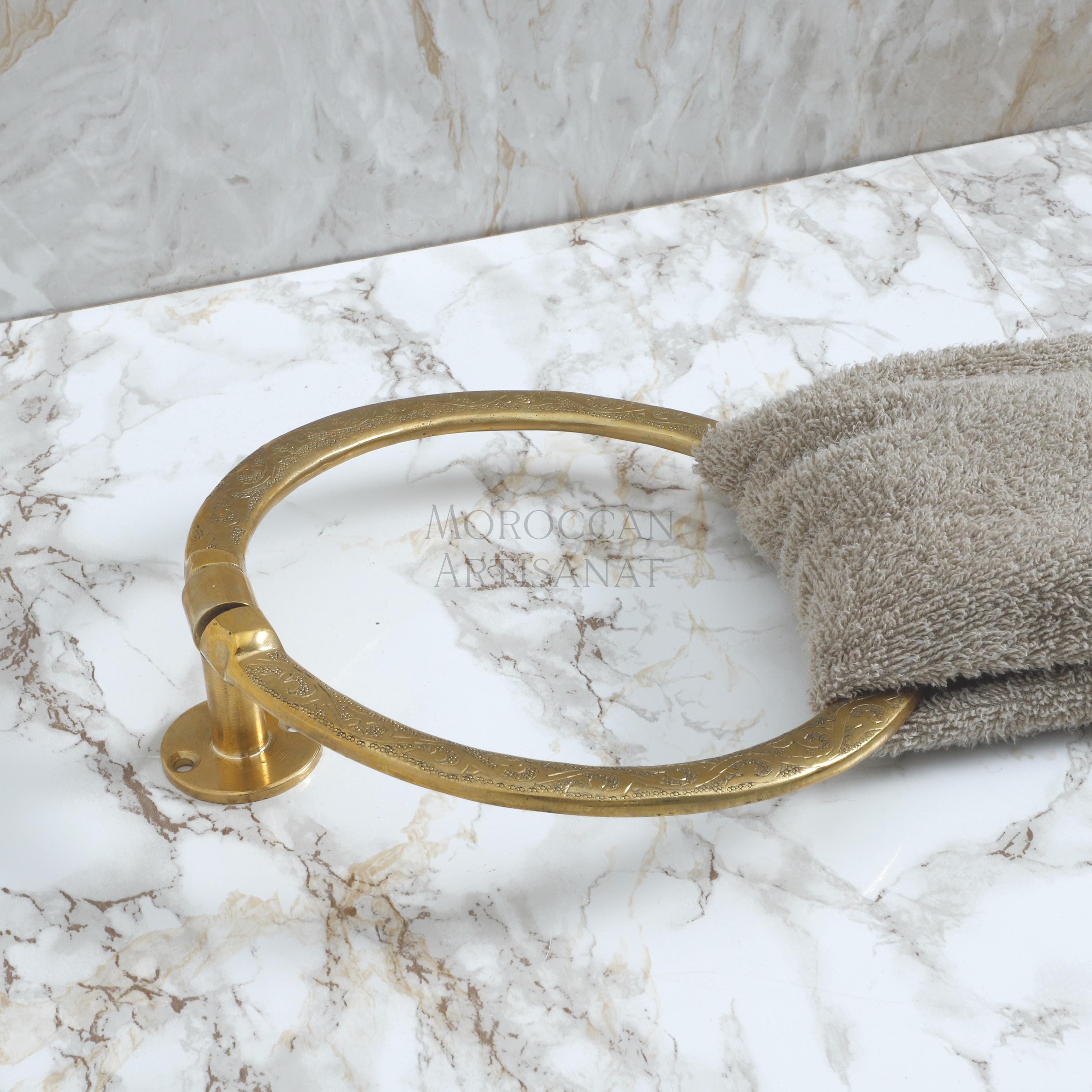 a gold towel ring on a marble counter