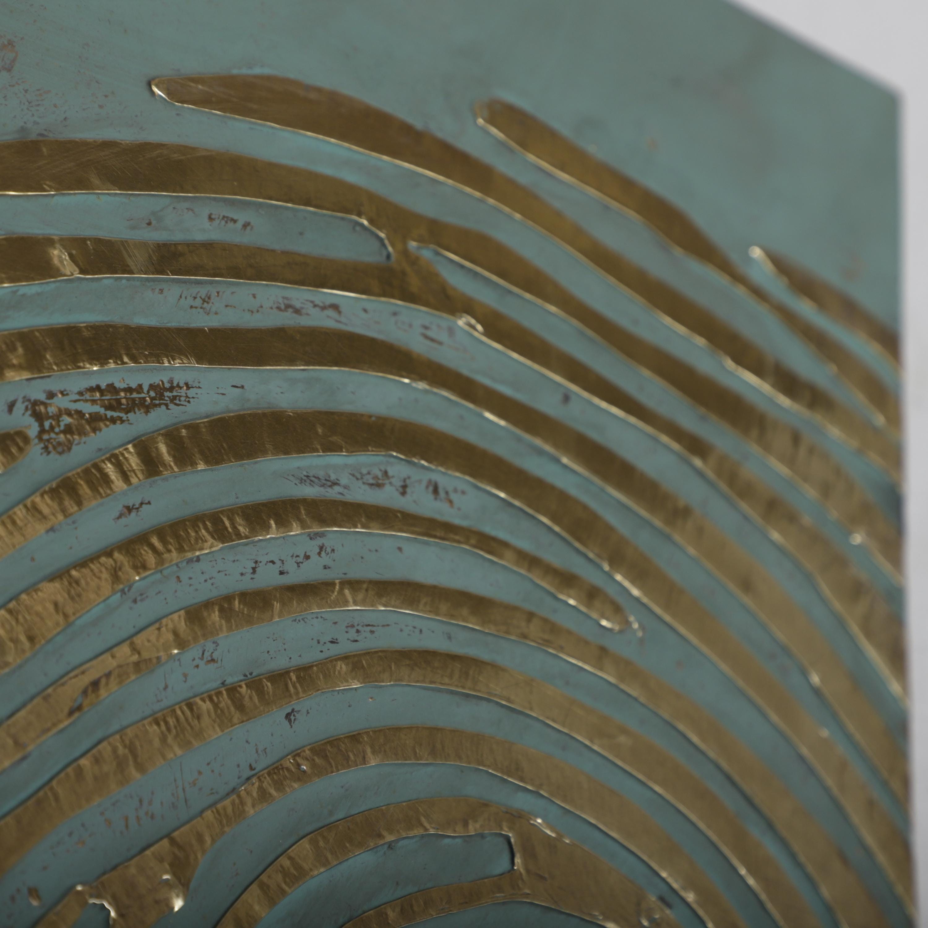 a close-up view of a textured surface with a repeating pattern of curved lines in shades of blue and gold.