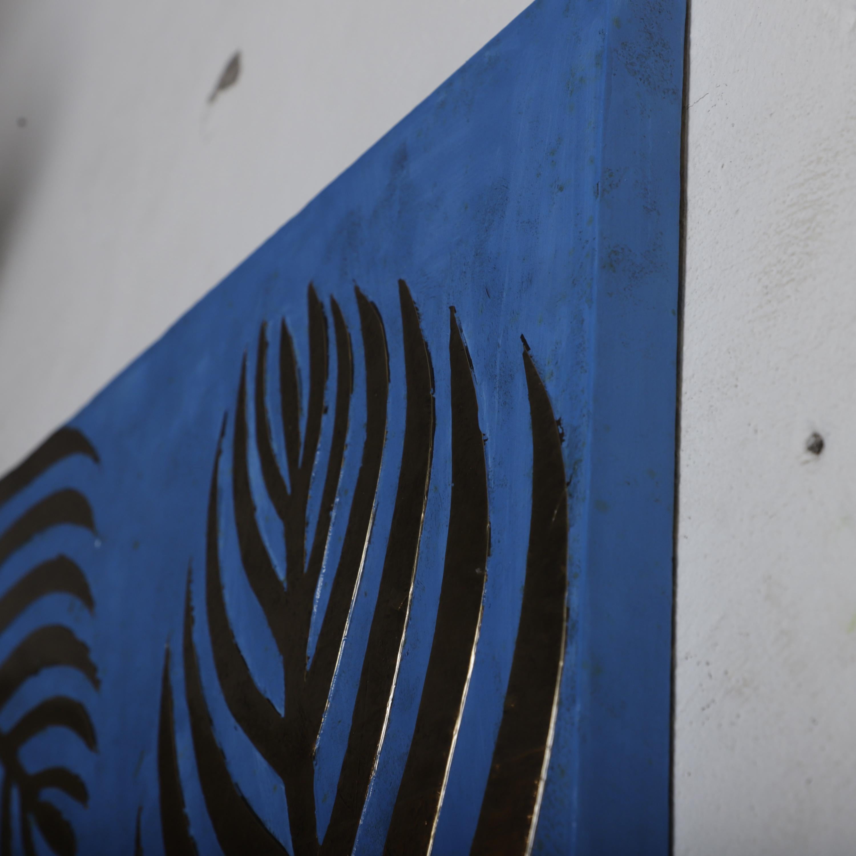a close-up view of a blue surface with a striking black leaf-like design.