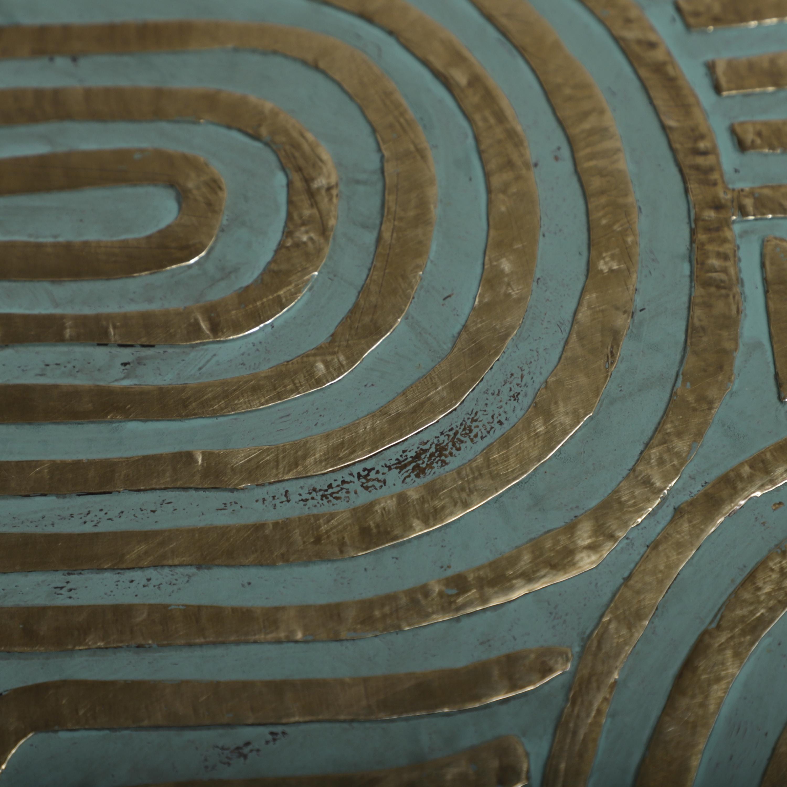 a close-up view of a textured surface with a repeating pattern of curved lines in shades of blue and gold.