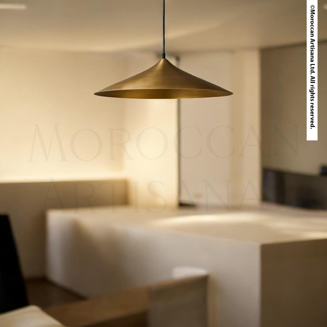 a modern, minimalist interior design with a gold pendant light hanging from the ceiling.