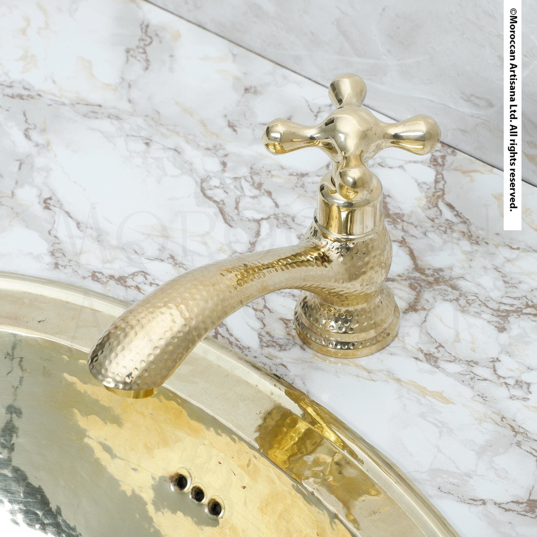 A close-up view of a gold-colored bathroom faucet and sink set against a marble countertop.
