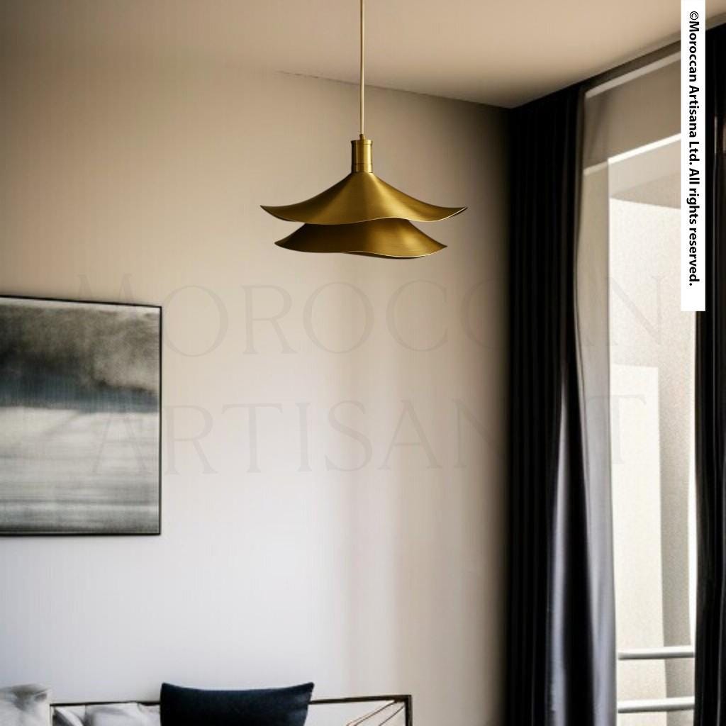 a modern interior design with a gold pendant light hanging from the ceiling, a black and white abstract painting on the wall, and a window with black curtains.
