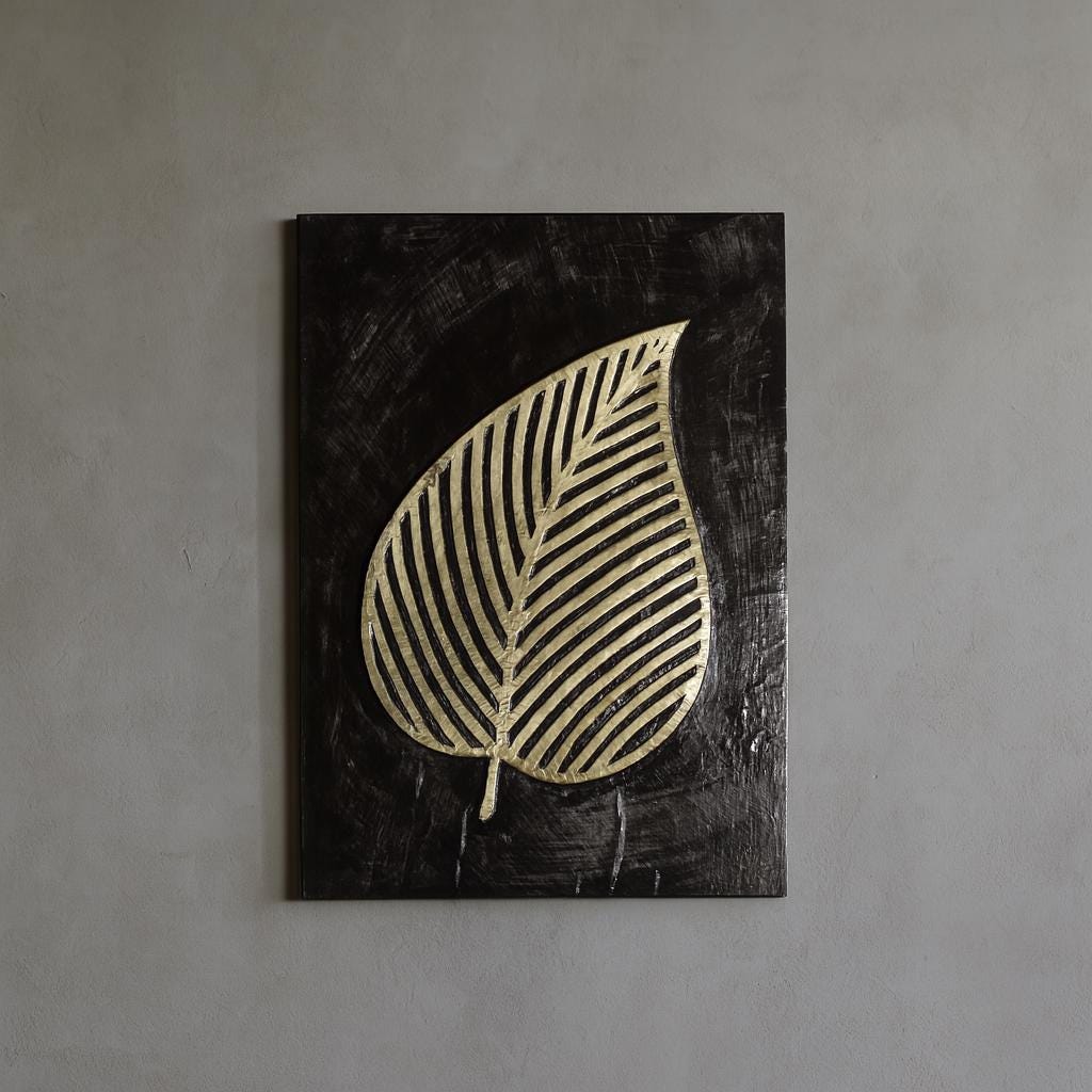 a black rectangular frame with a gold leaf design on it.