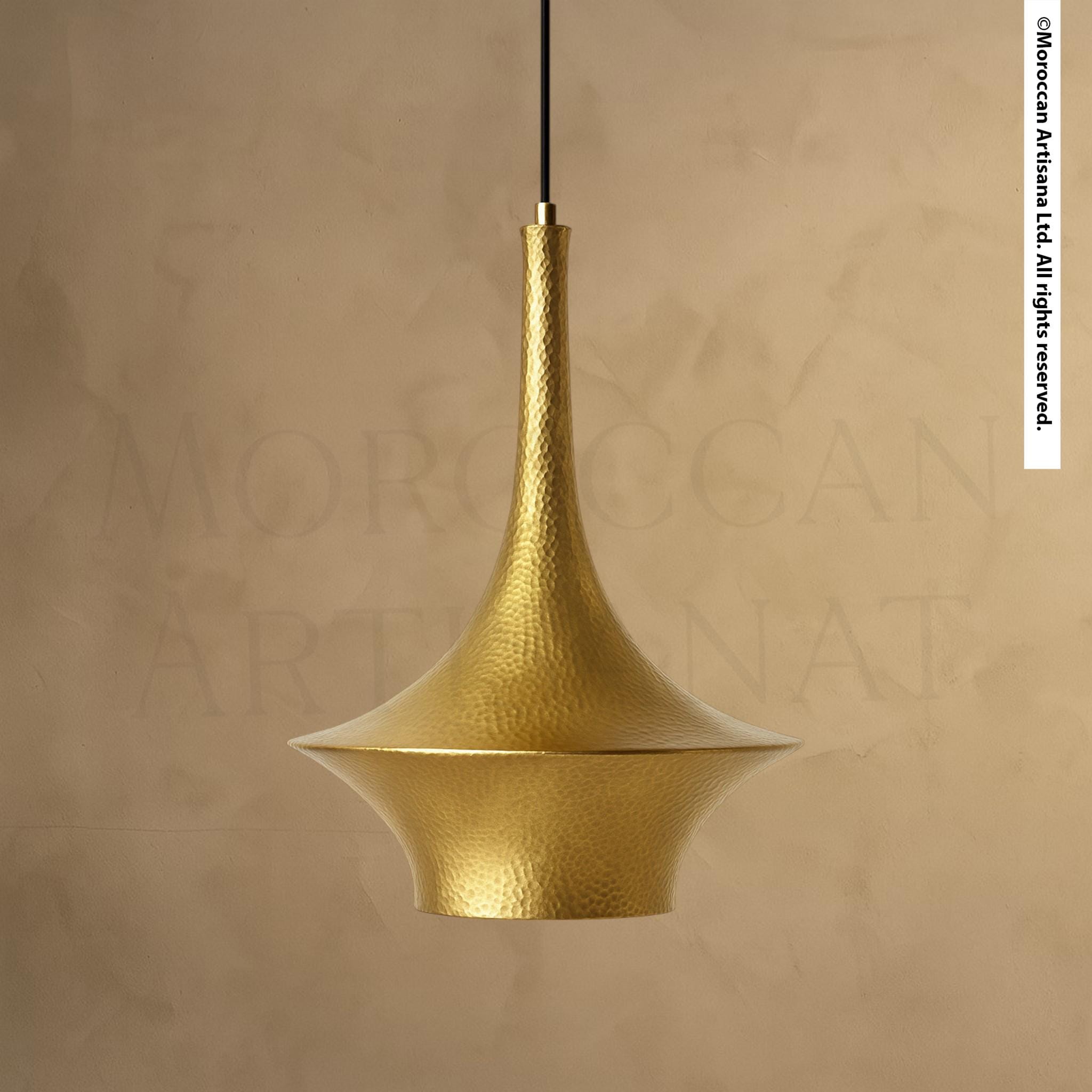 A gold-colored pendant light fixture with a textured, metallic finish hangs from the ceiling.