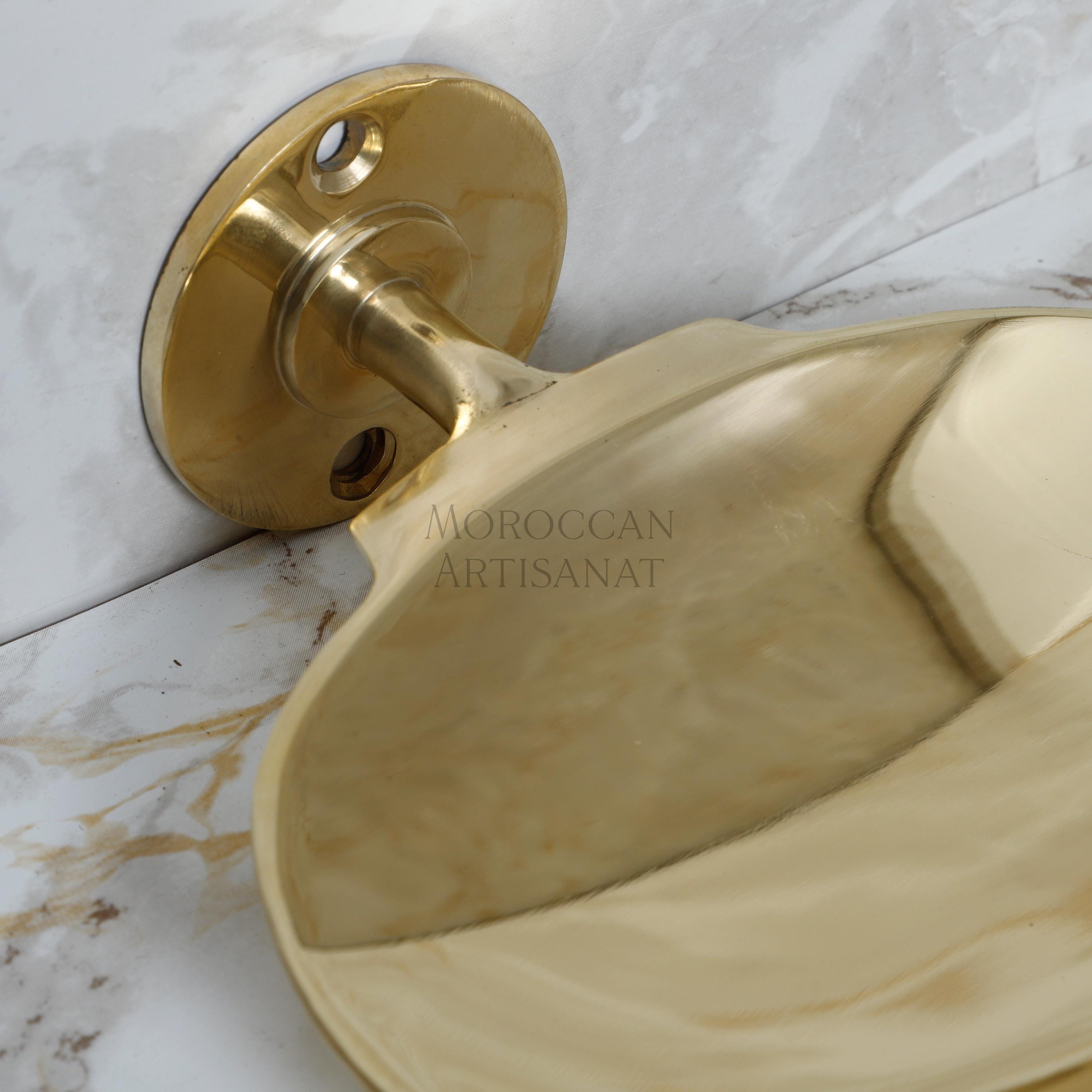 a close up of a bathroom sink with a gold faucet
